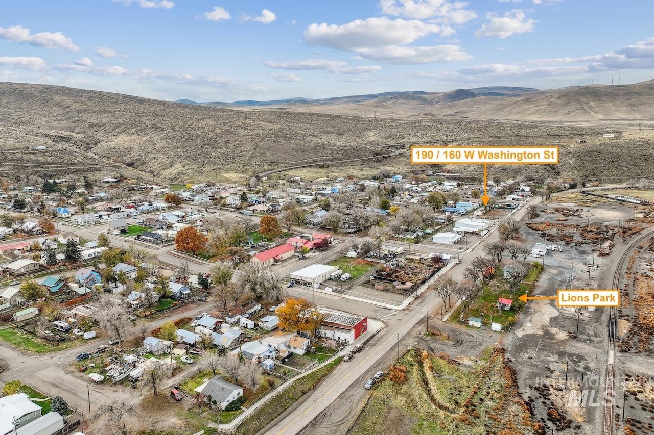 Aerial overview of property's location featuring mountains and nearby suburban area
