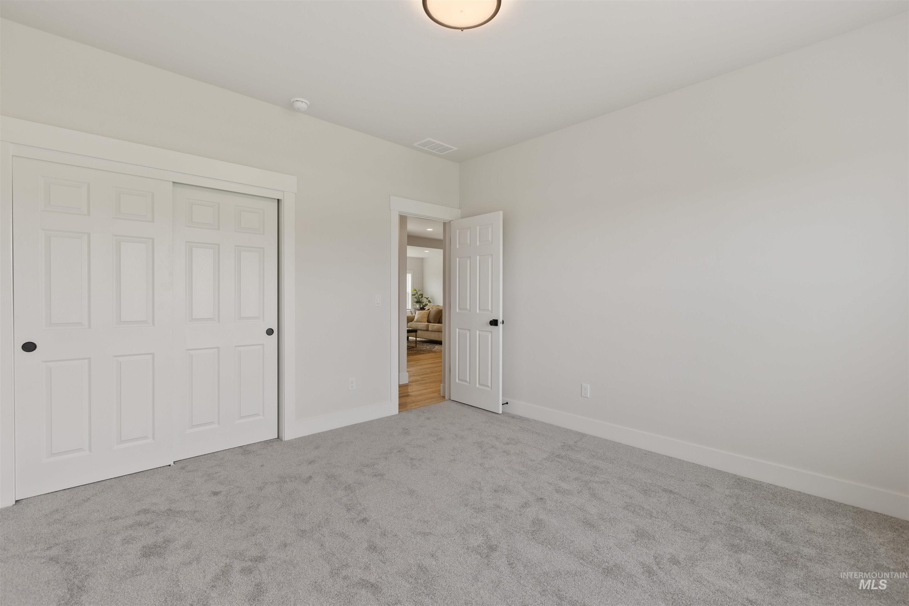 Unfurnished bedroom featuring carpet floors and a closet