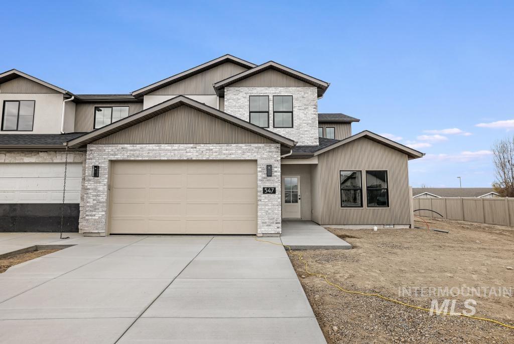 View of front of property featuring driveway and a garage