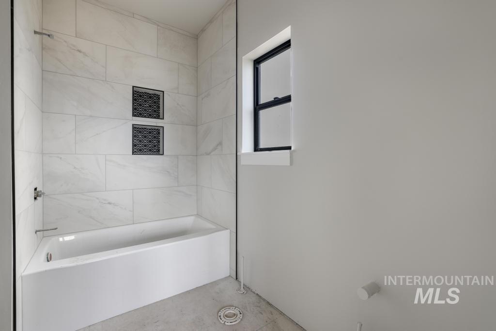 Bathroom featuring washtub / shower combination