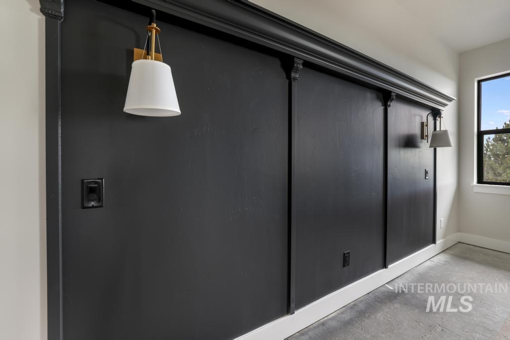 Detailed view of unfinished concrete flooring and baseboards