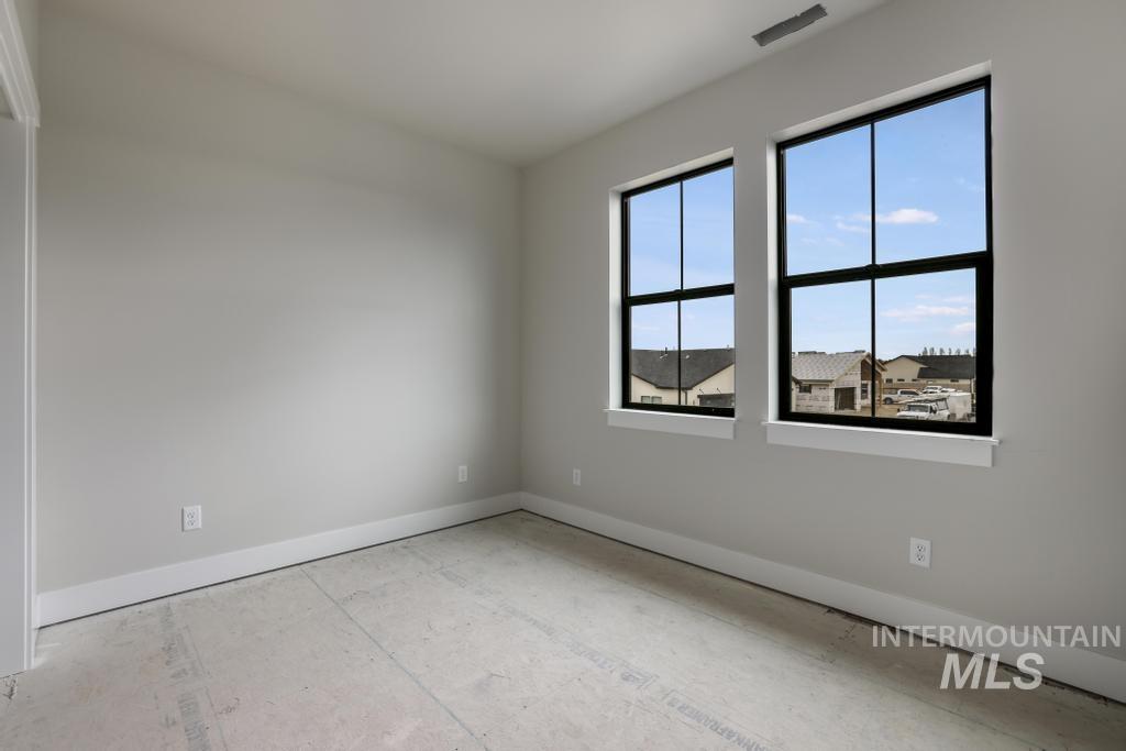 Unfurnished room featuring baseboards