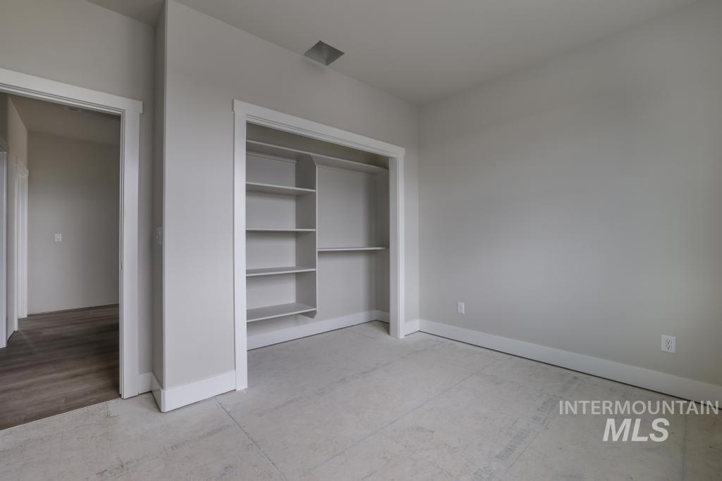 Unfurnished bedroom featuring baseboards and a closet