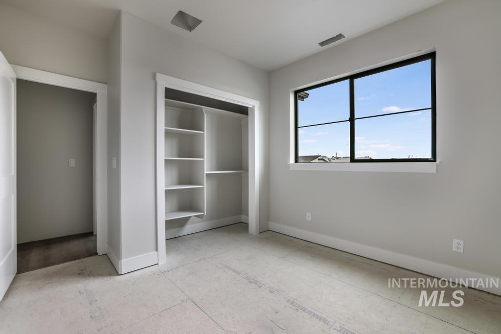 Unfurnished bedroom with baseboards and a closet