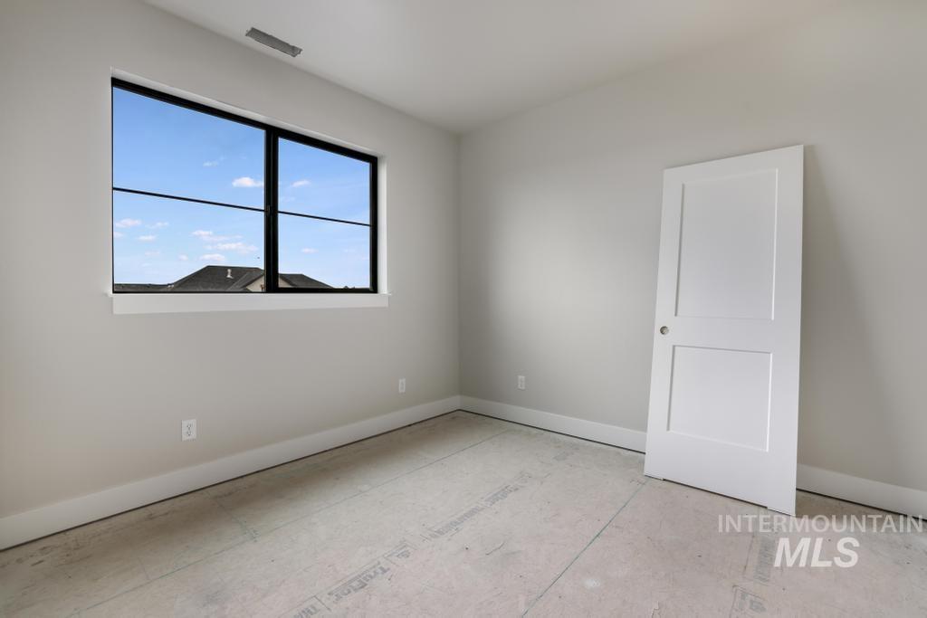 Unfurnished room with baseboards