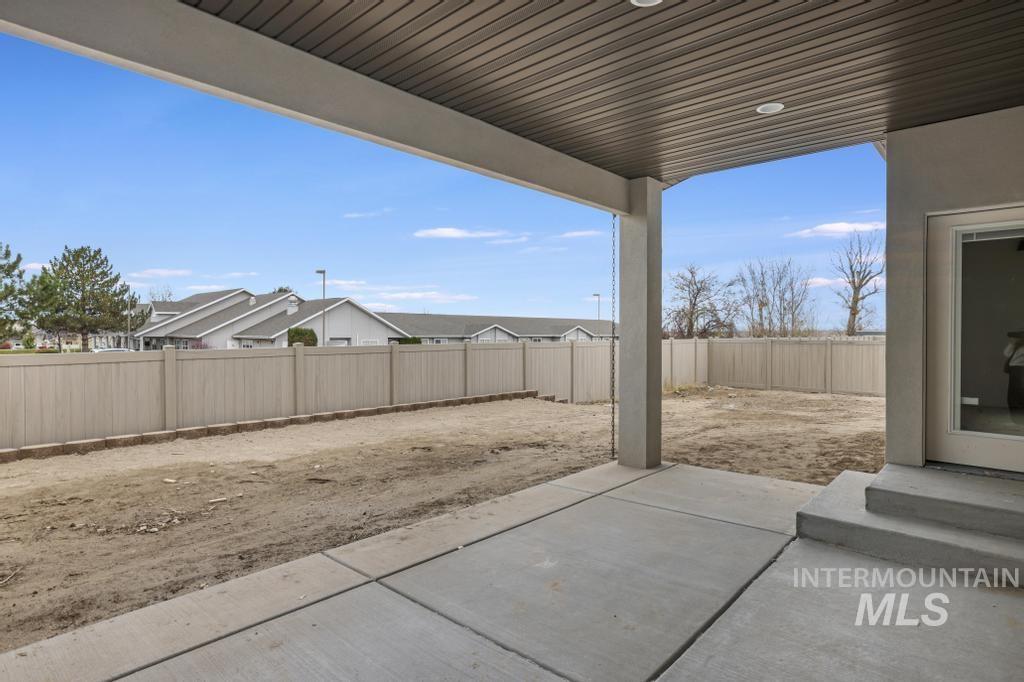 Fenced backyard with a patio