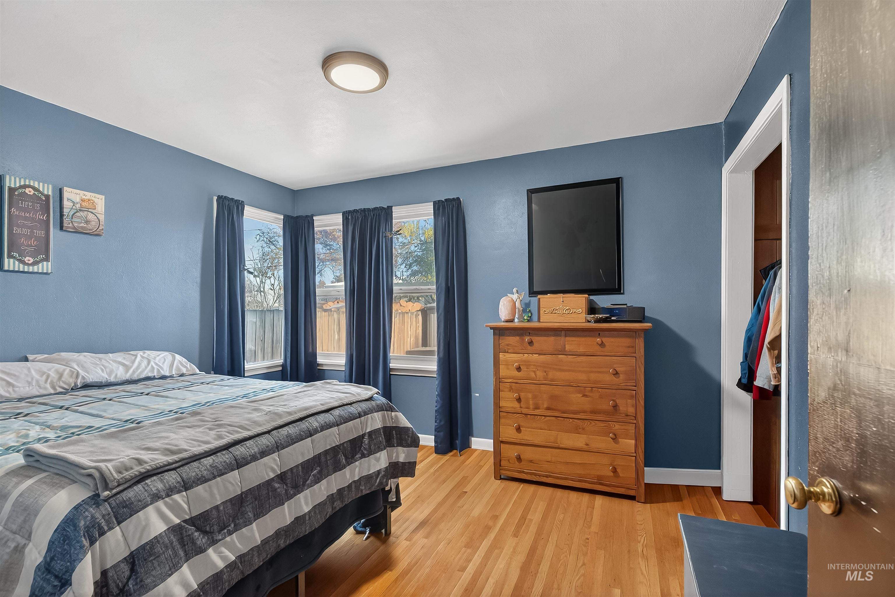 Bedroom with light wood finished floors and baseboards
