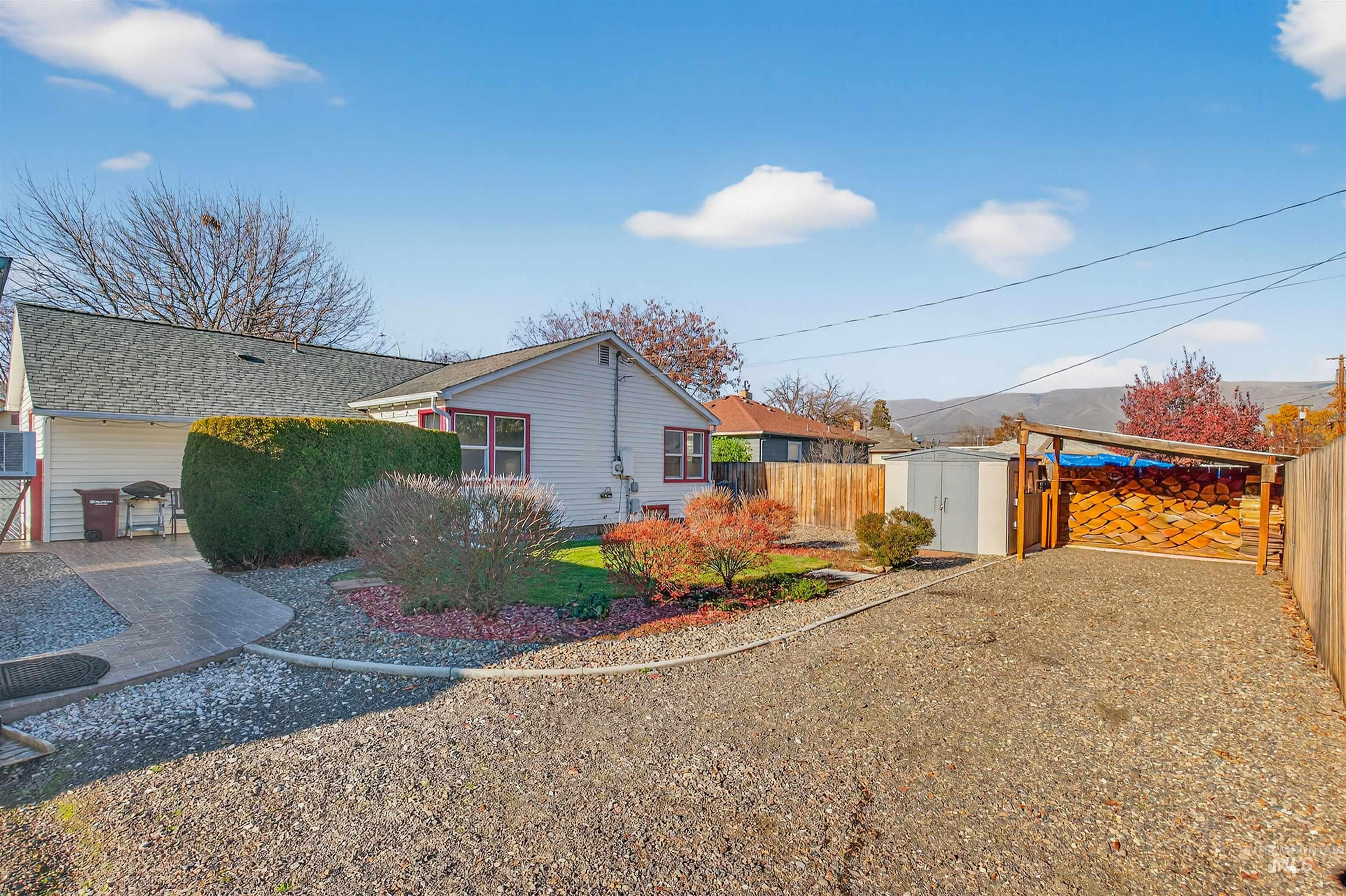 View of home's exterior featuring a fenced backyard, a shed, and a patio area