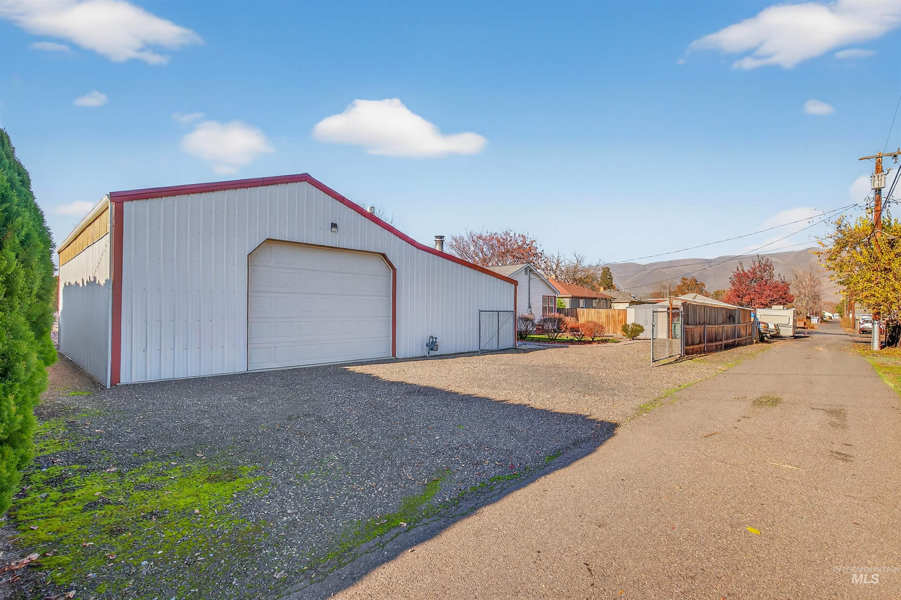 Detached garage with gravel driveway