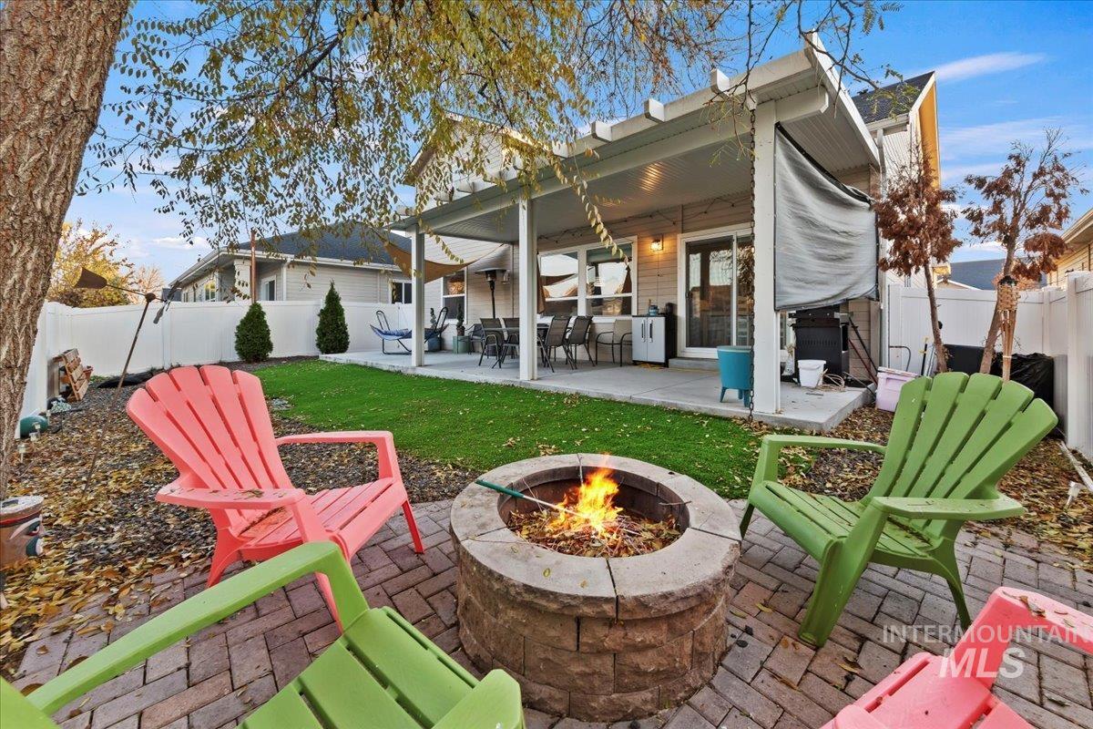 Rear view of house featuring a patio area and a fenced backyard