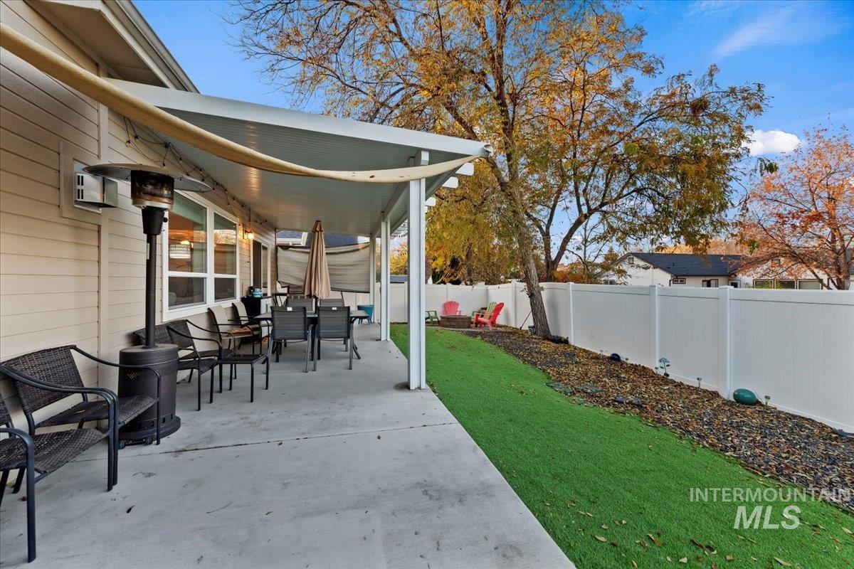 Fenced backyard featuring a patio area and outdoor dining space