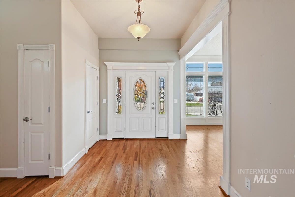 Foyer featuring baseboards and light wood-style flooring