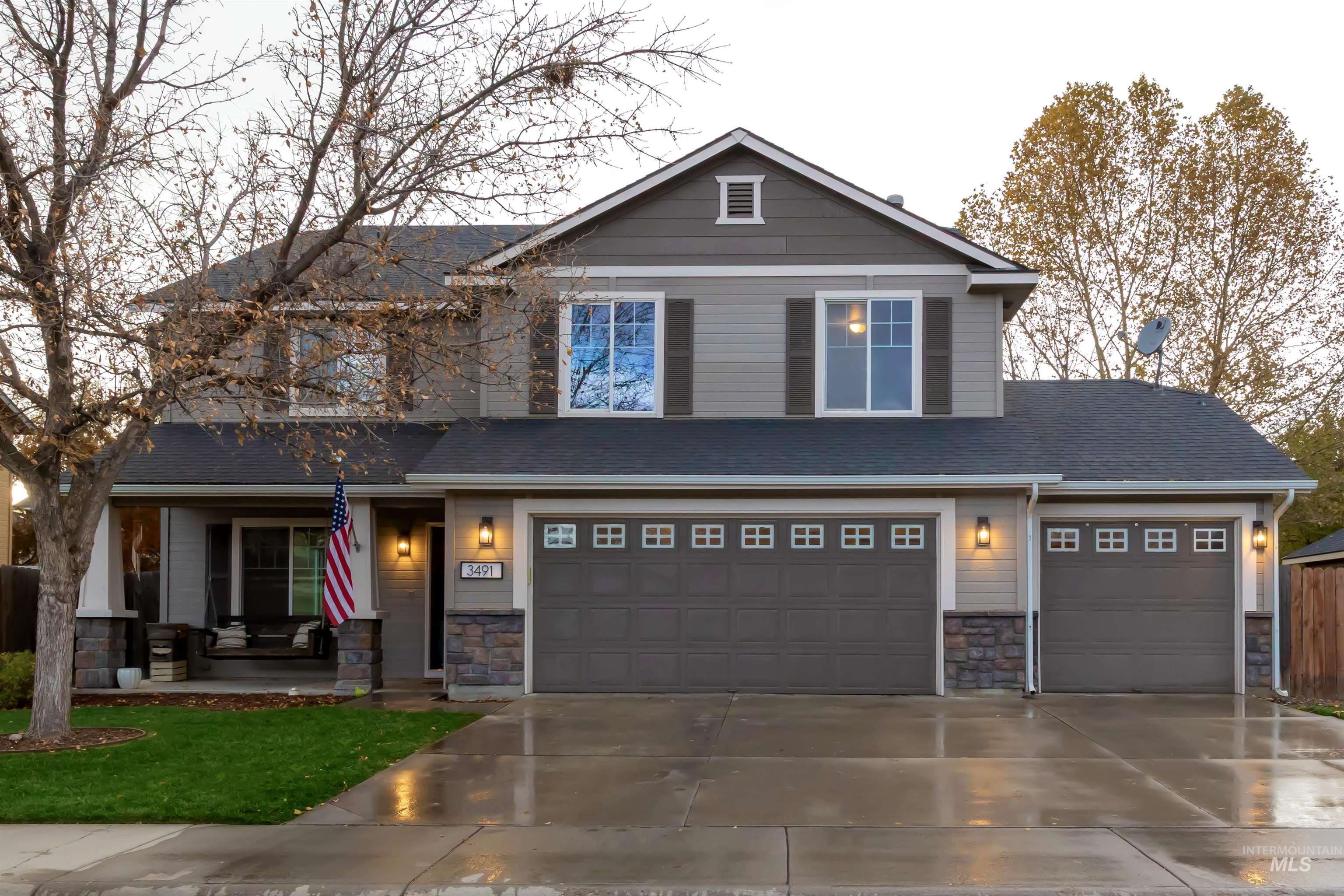 Craftsman inspired home with stone siding, driveway, a garage, and covered porch