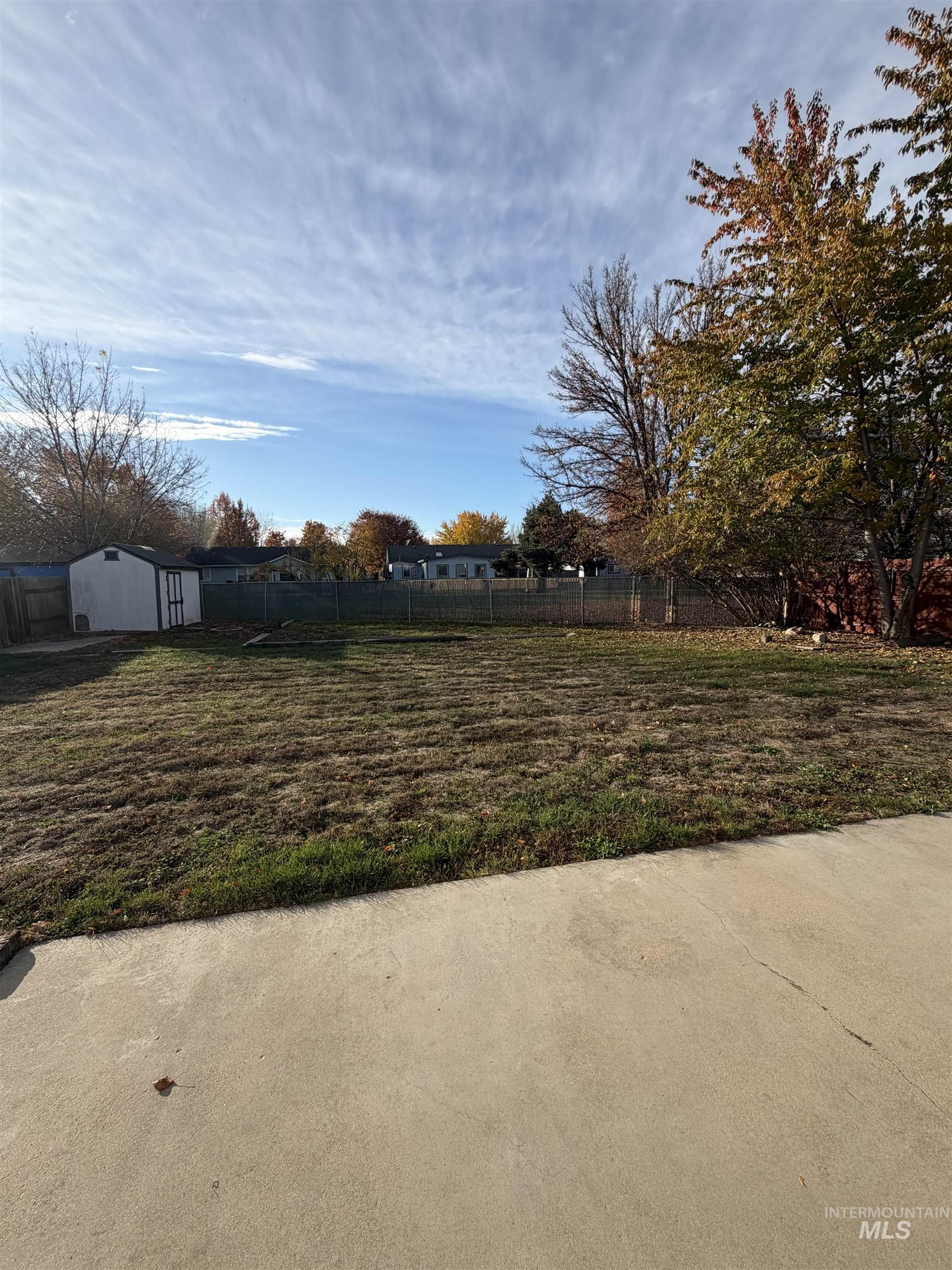View of yard featuring a storage unit