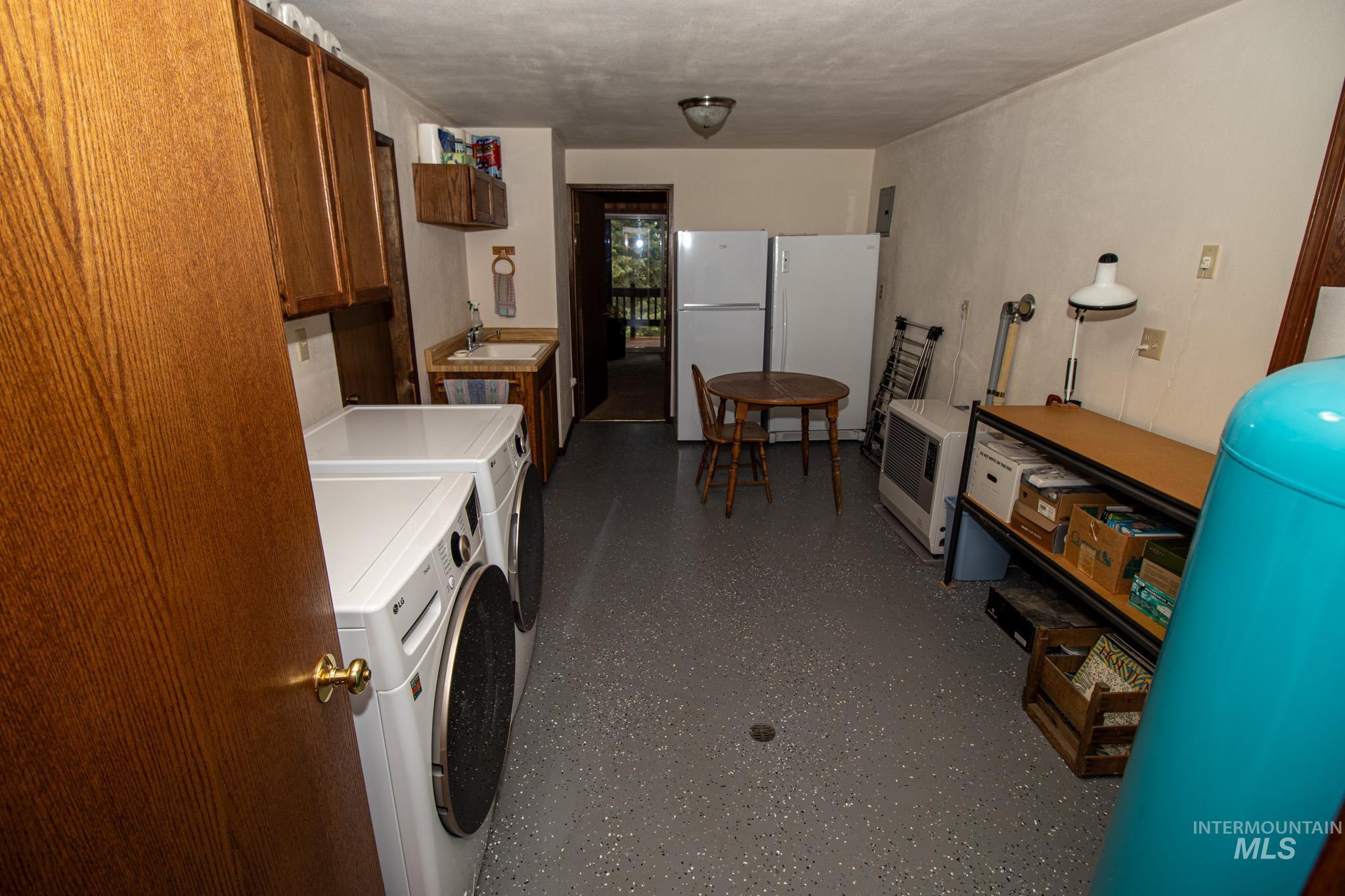Laundry room with washer and clothes dryer