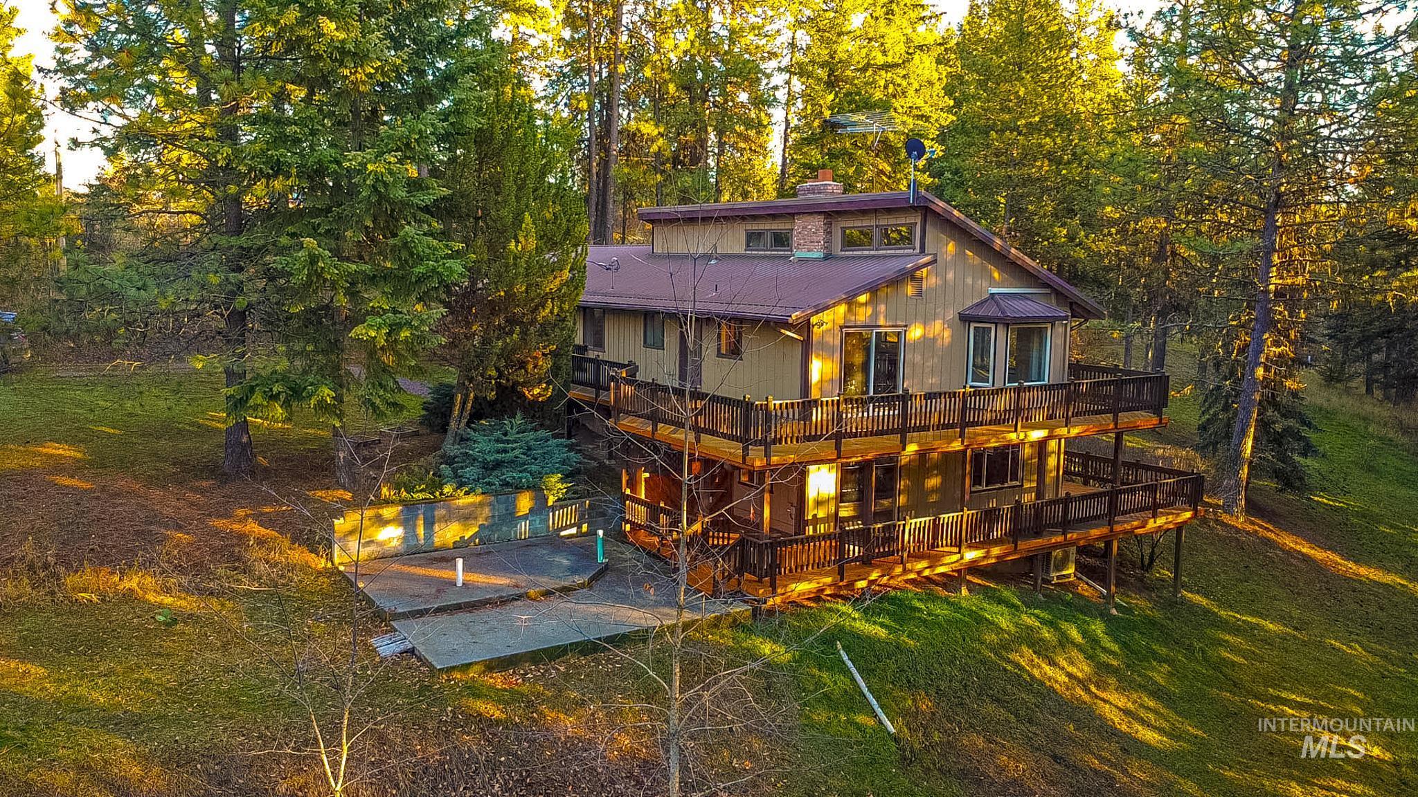 Back of property with a chimney and a wooden deck