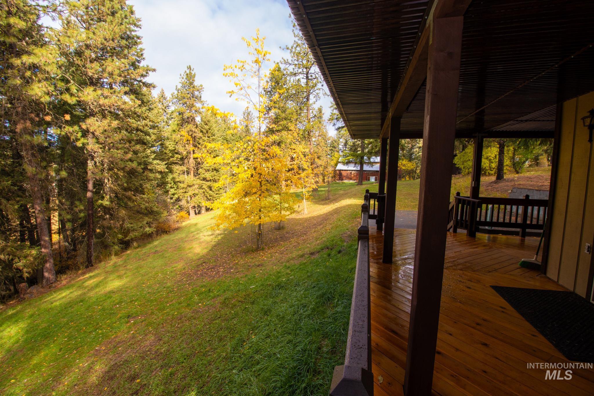 View of green lawn featuring a deck