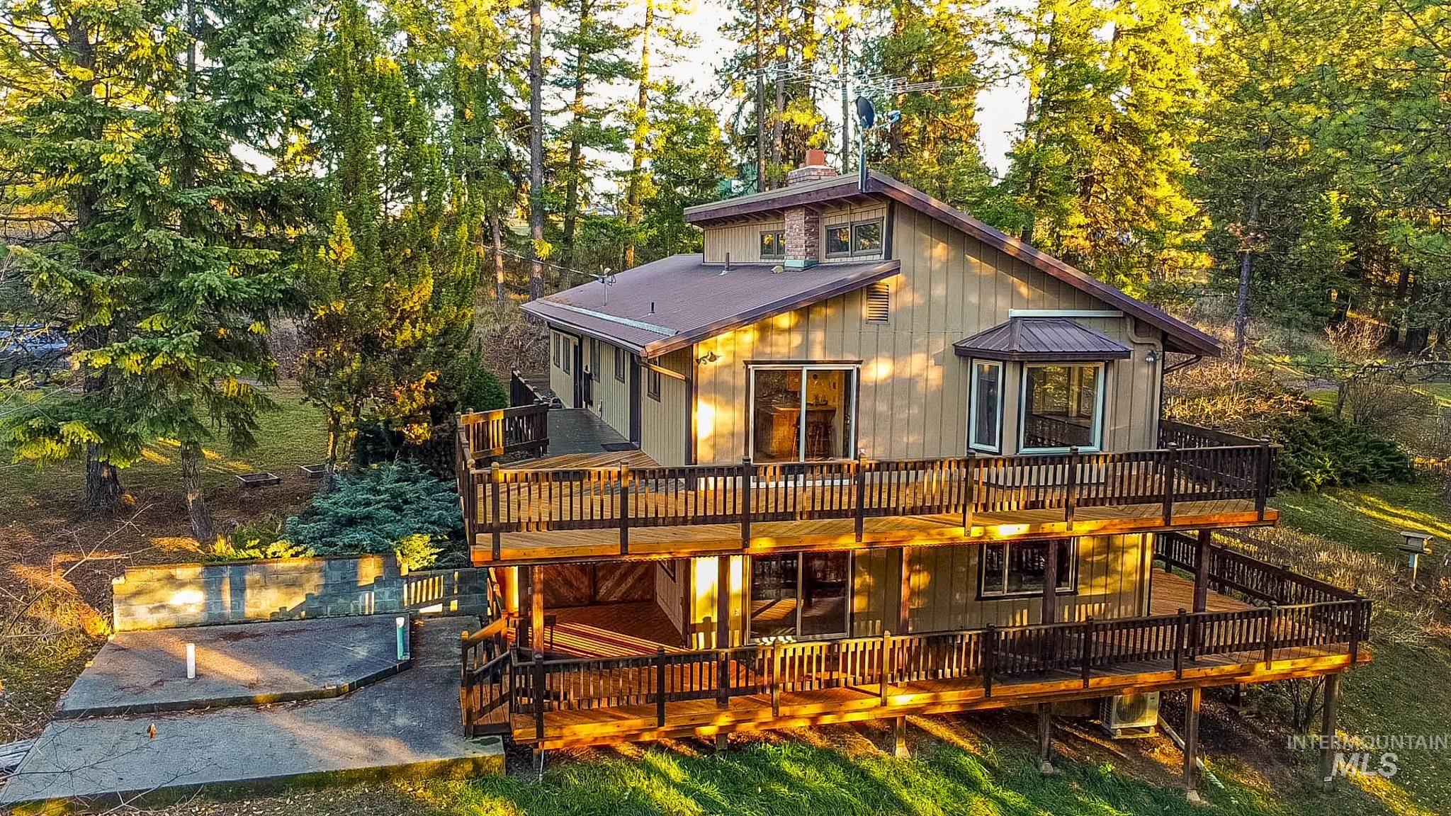 Rear view of house with a deck and a metal roof
