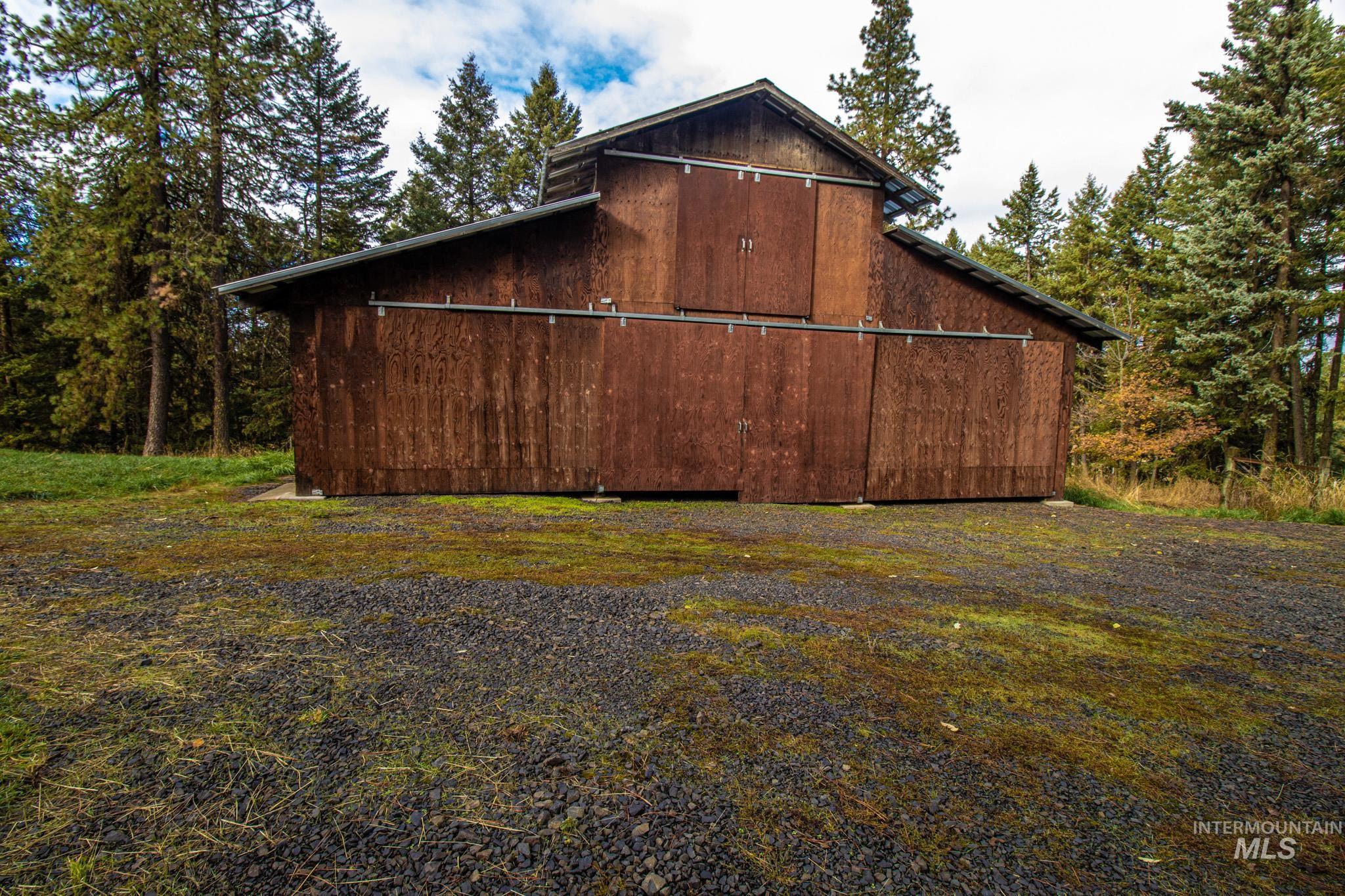 View of home's exterior featuring an outdoor structure and a barn