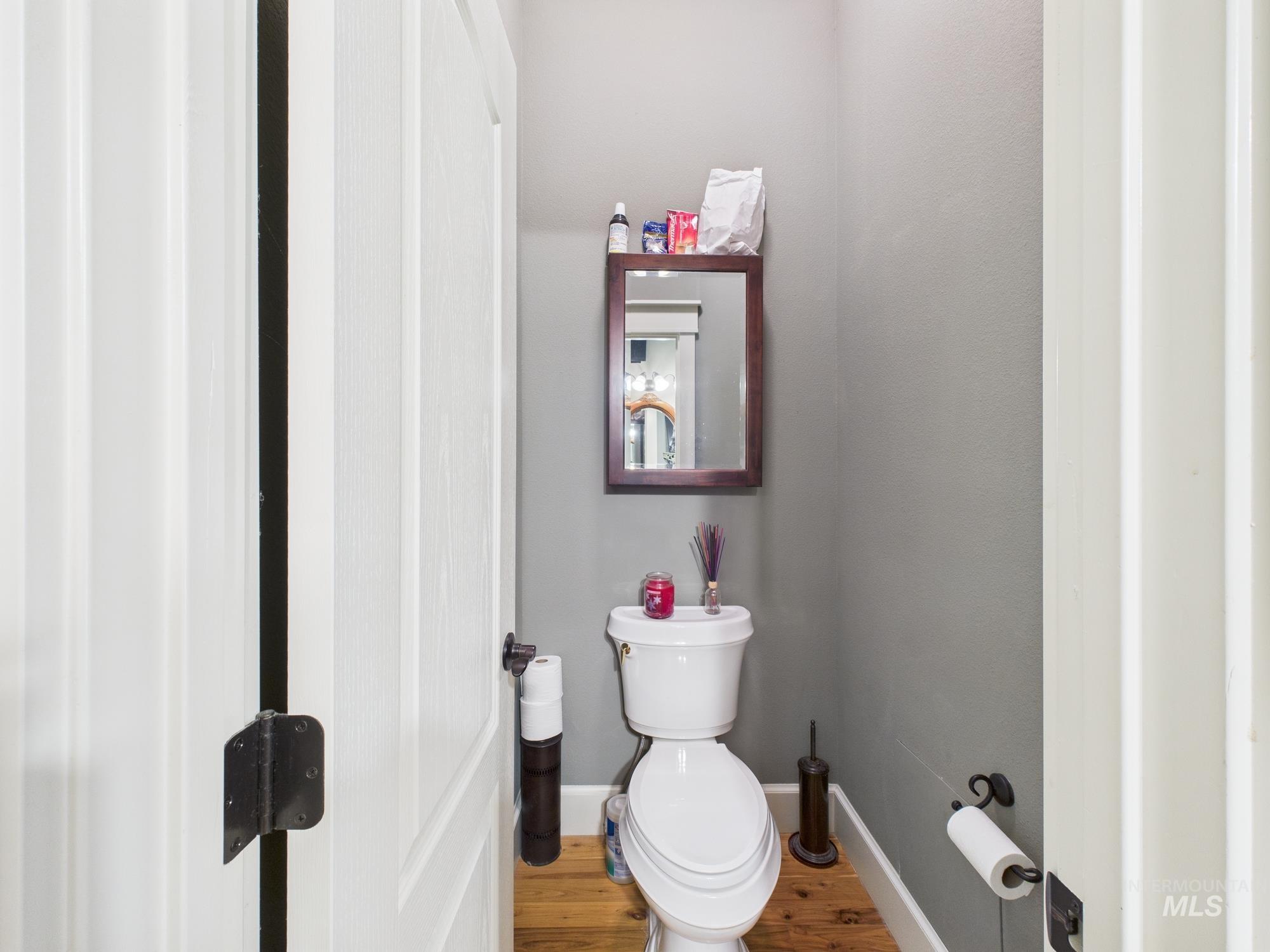 Bathroom with toilet and wood finished floors