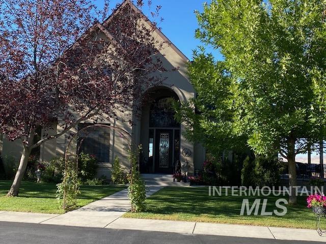 View of exterior entry with a yard