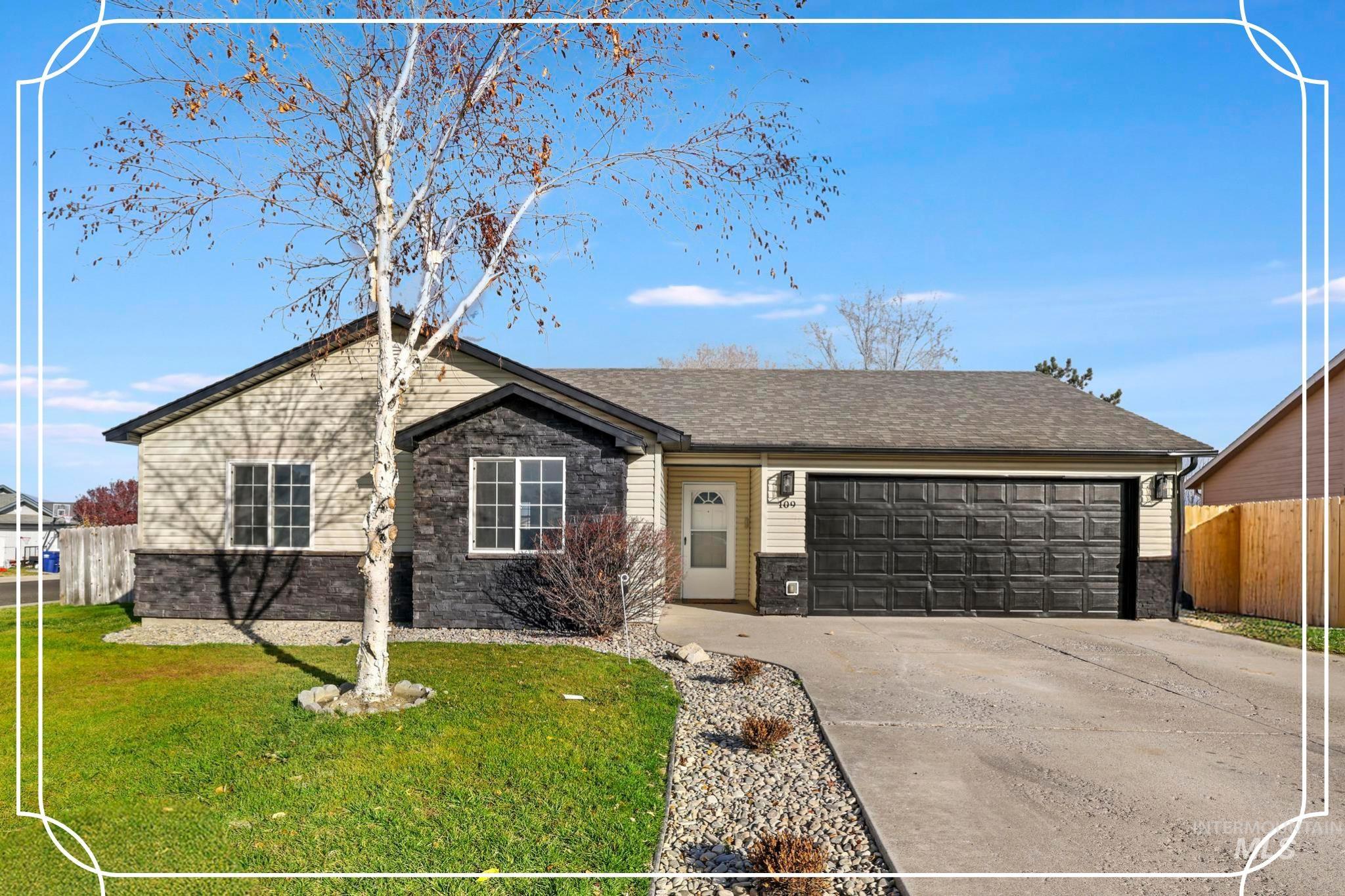 Ranch-style home with concrete driveway, a garage, and stone siding