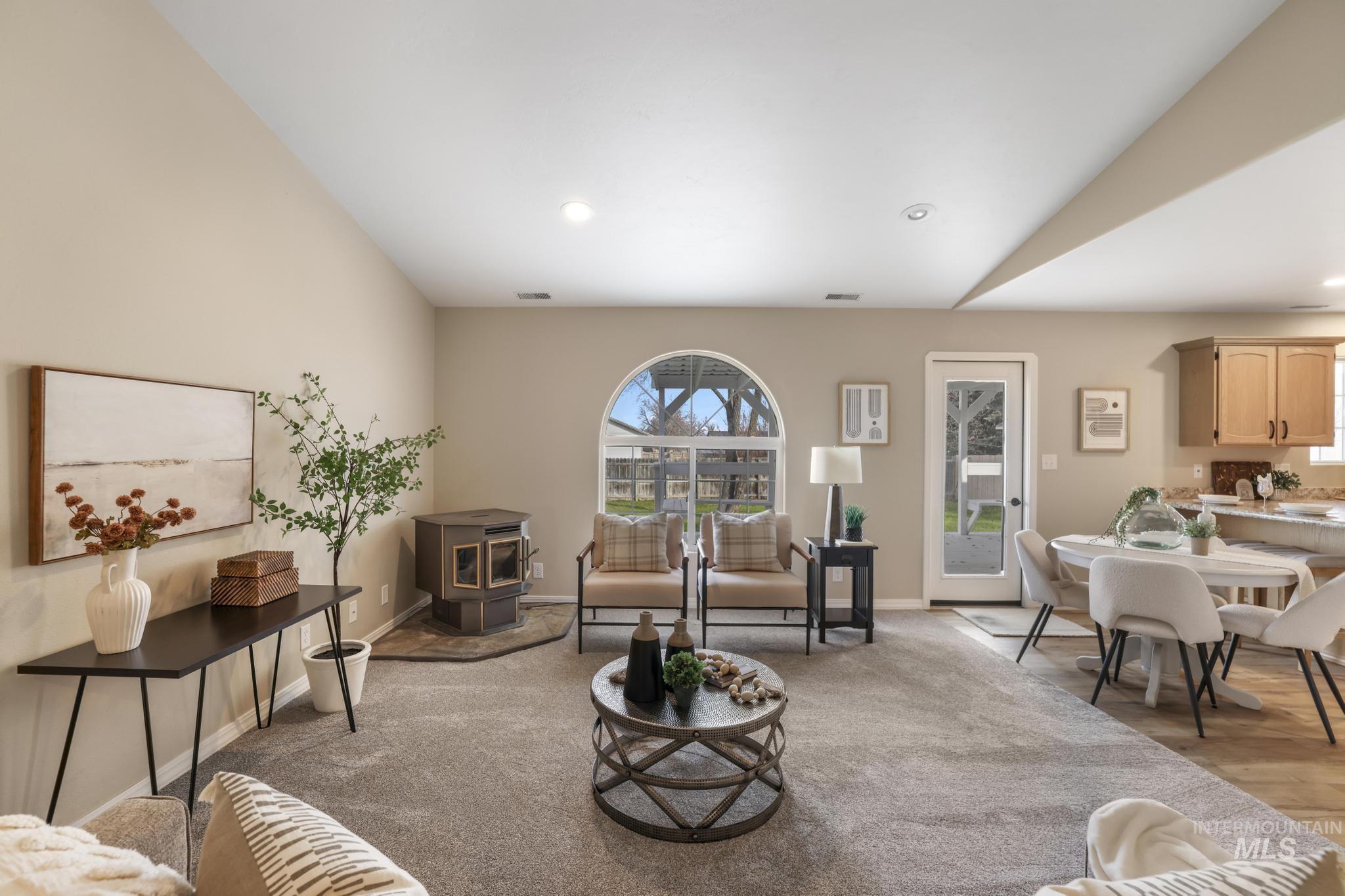 Living room with a wood stove and recessed lighting