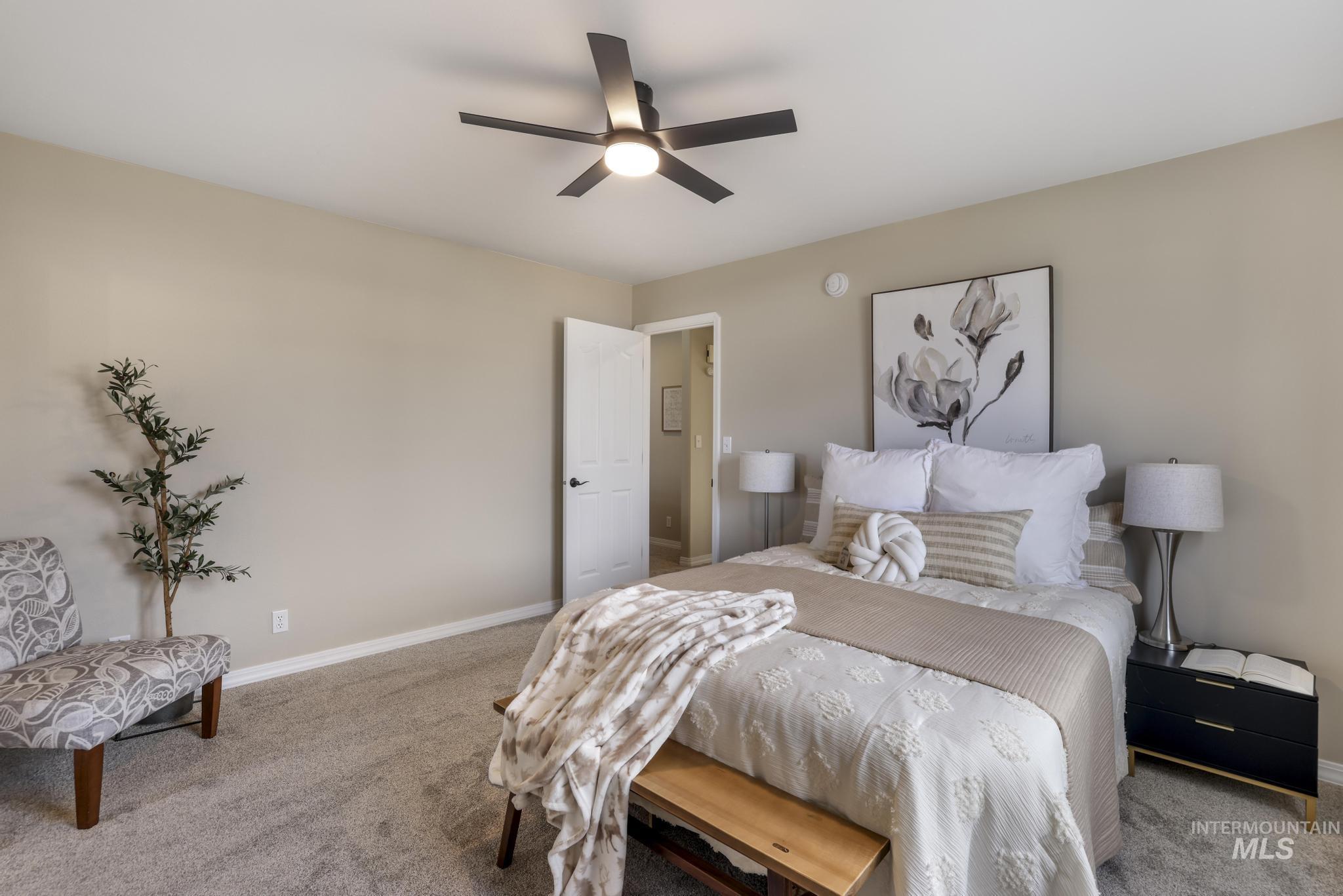 Bedroom with carpet floors and a ceiling fan