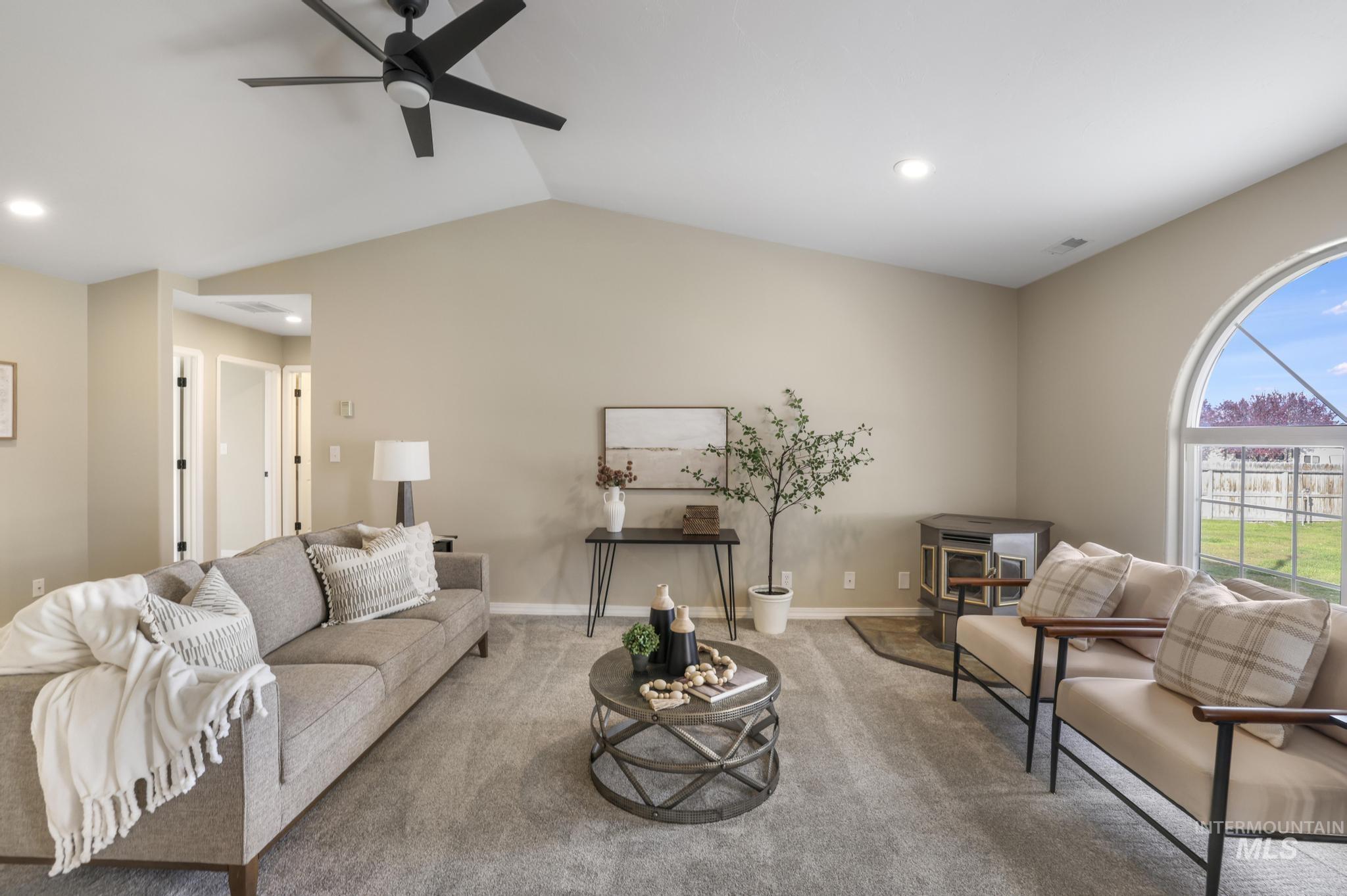 Living area featuring carpet flooring, recessed lighting, vaulted ceiling, and ceiling fan