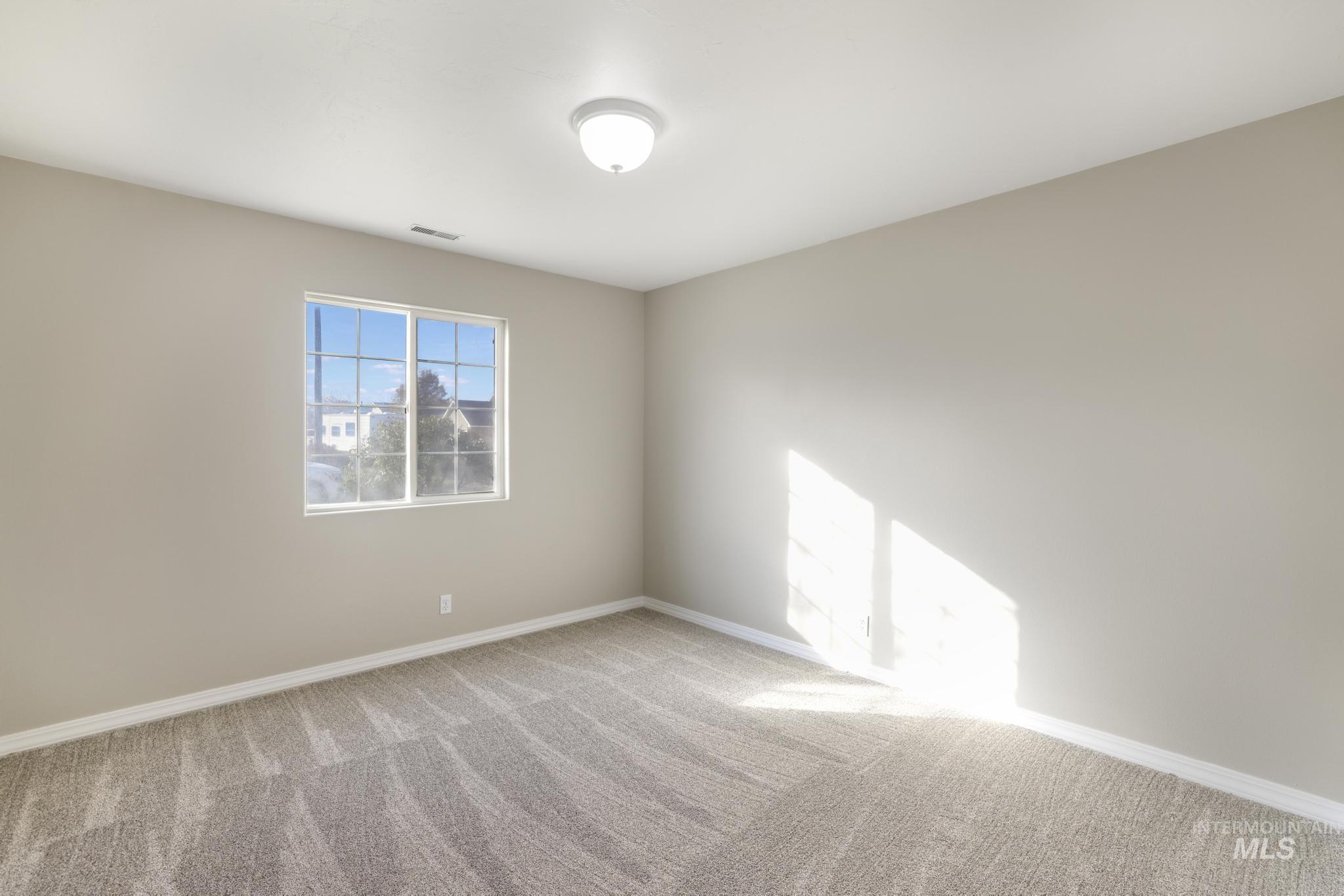Spare room with baseboards and carpet