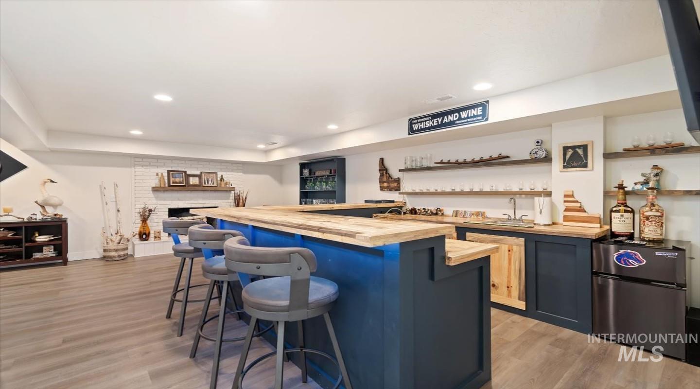 Wet bar with wrap-around seating and undercounter lighting