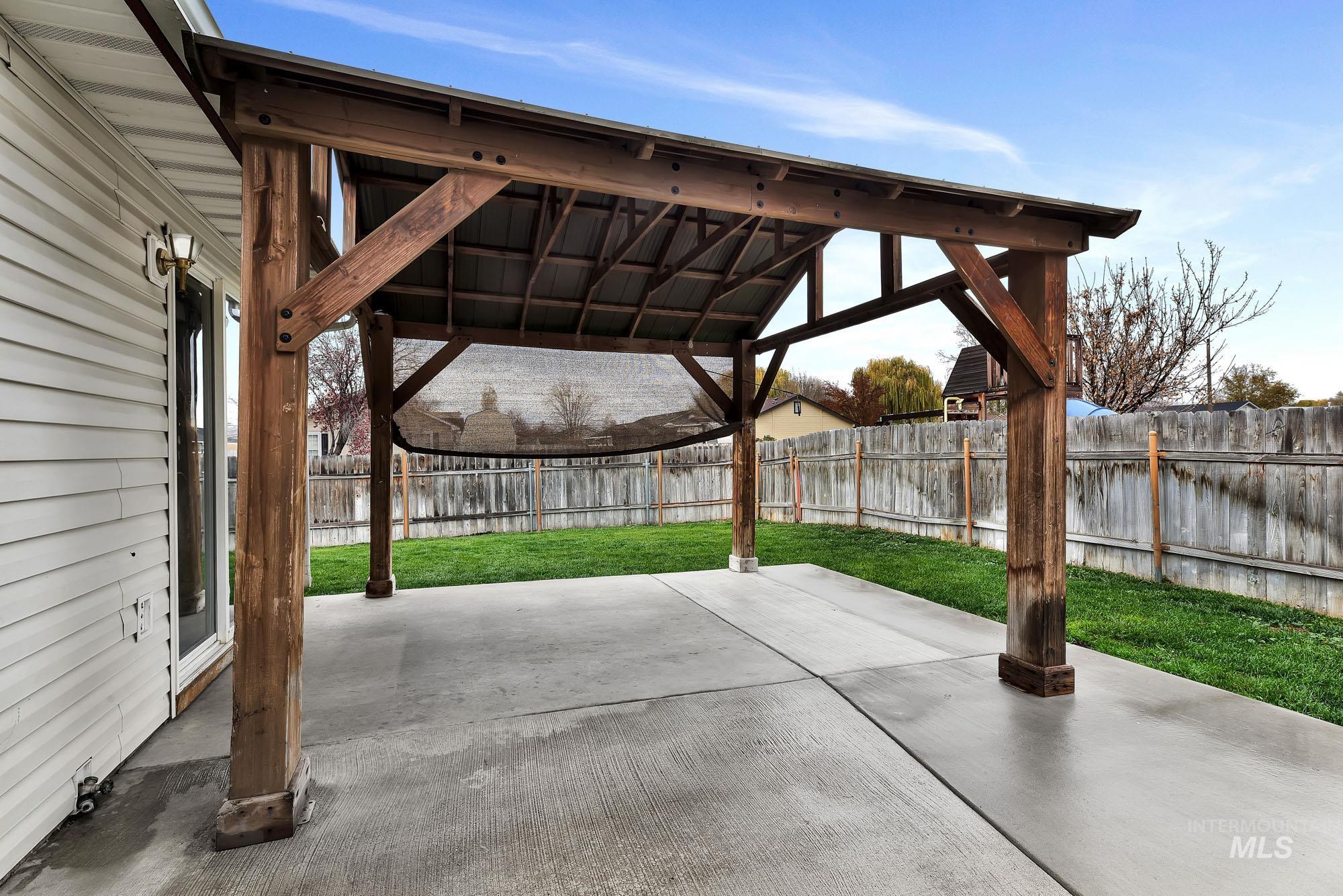 Fenced backyard featuring a patio
