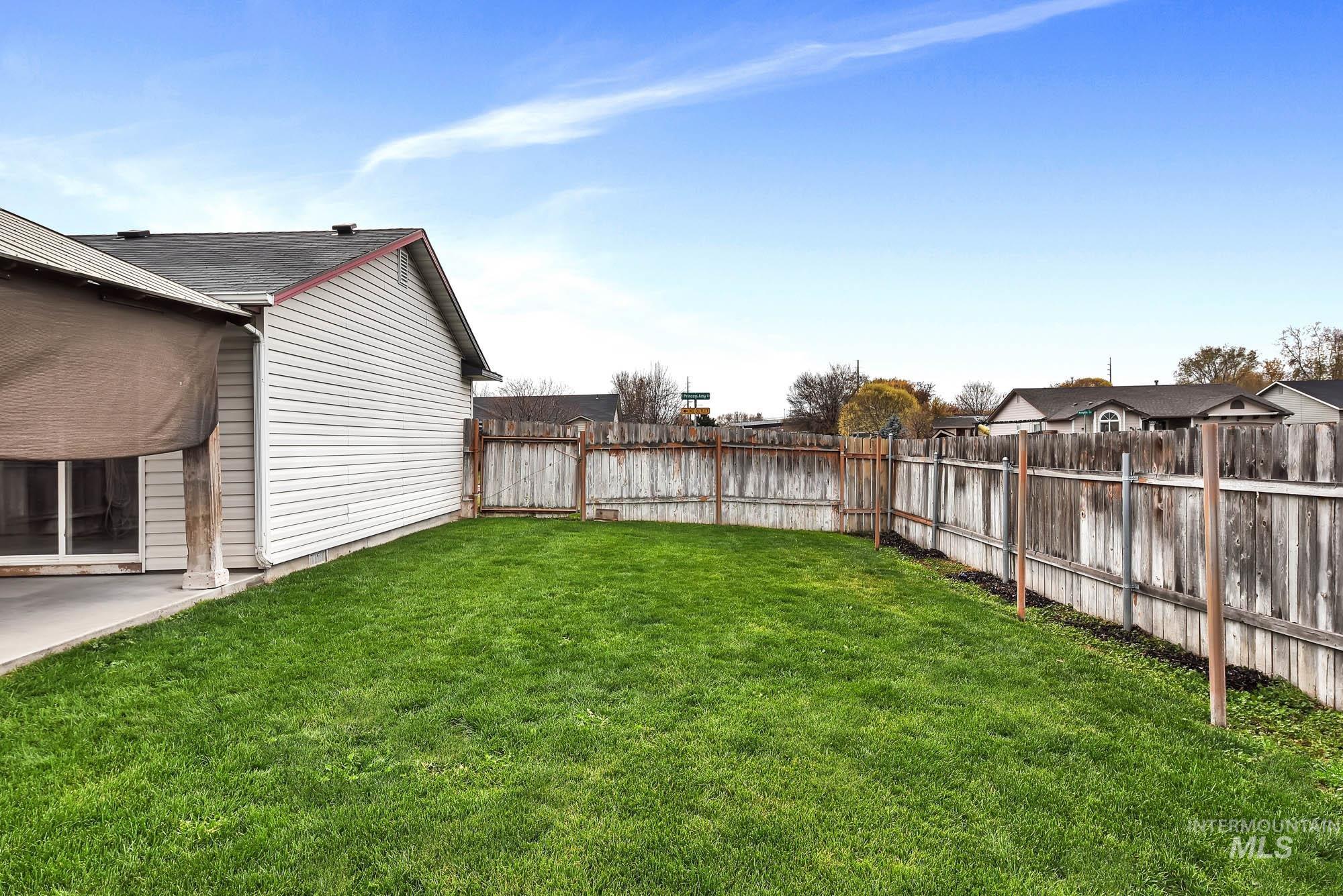 Fenced backyard with a patio