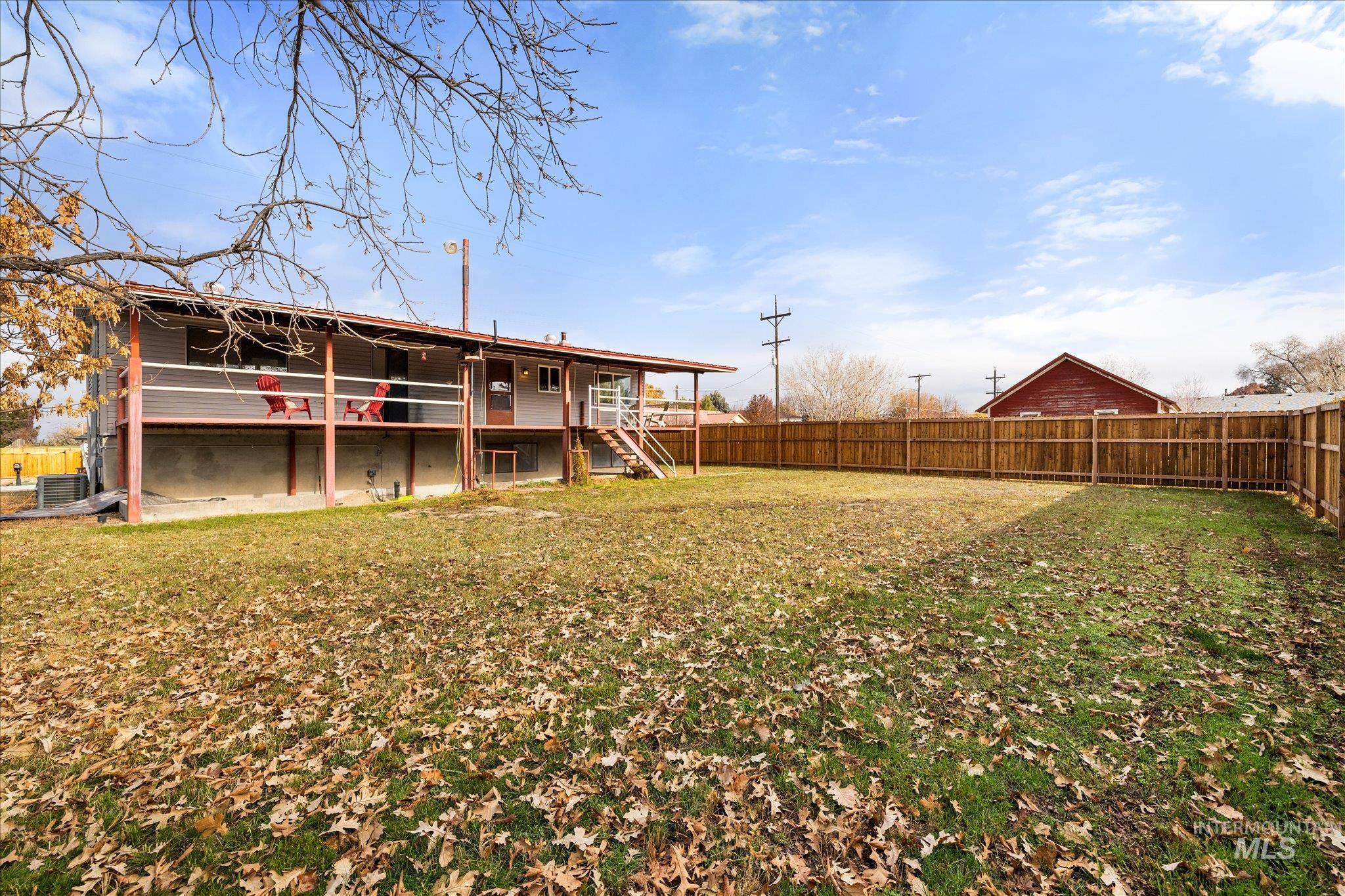 Back of house featuring a deck and a fenced backyard