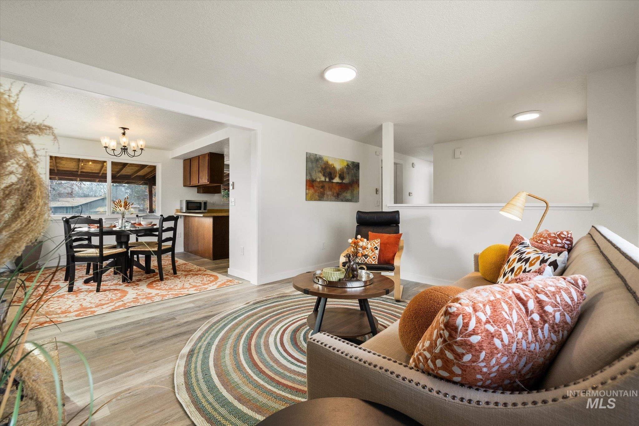 Living area featuring a chandelier and light wood finished floors