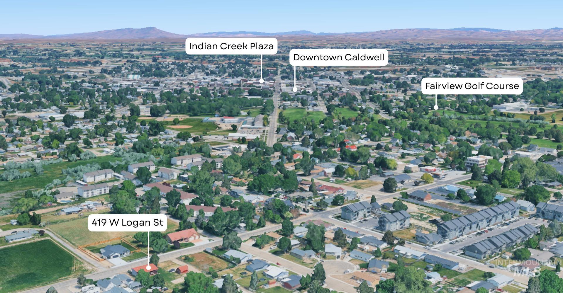 Aerial view of property and surrounding area with a mountainous background
