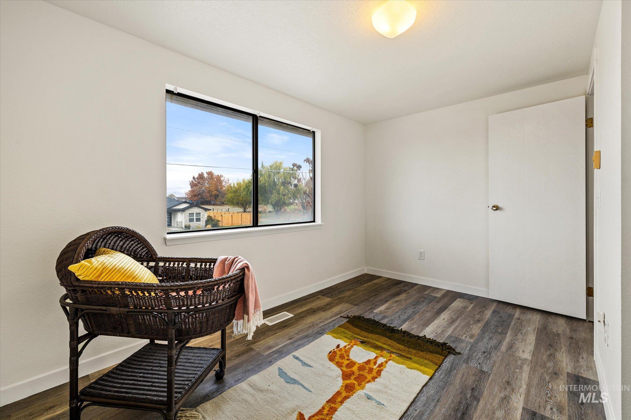 Living area featuring dark wood-style floors
