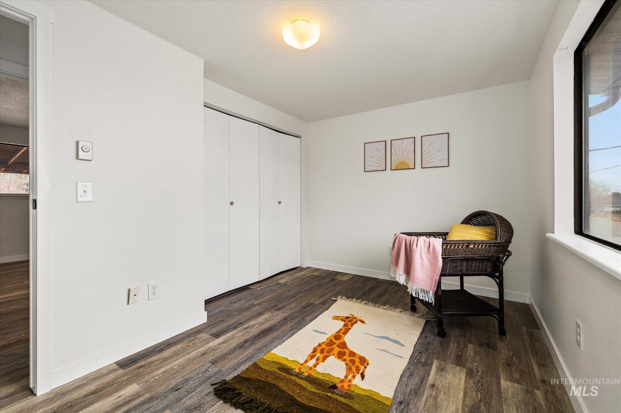 Office space with baseboards and dark wood-style flooring