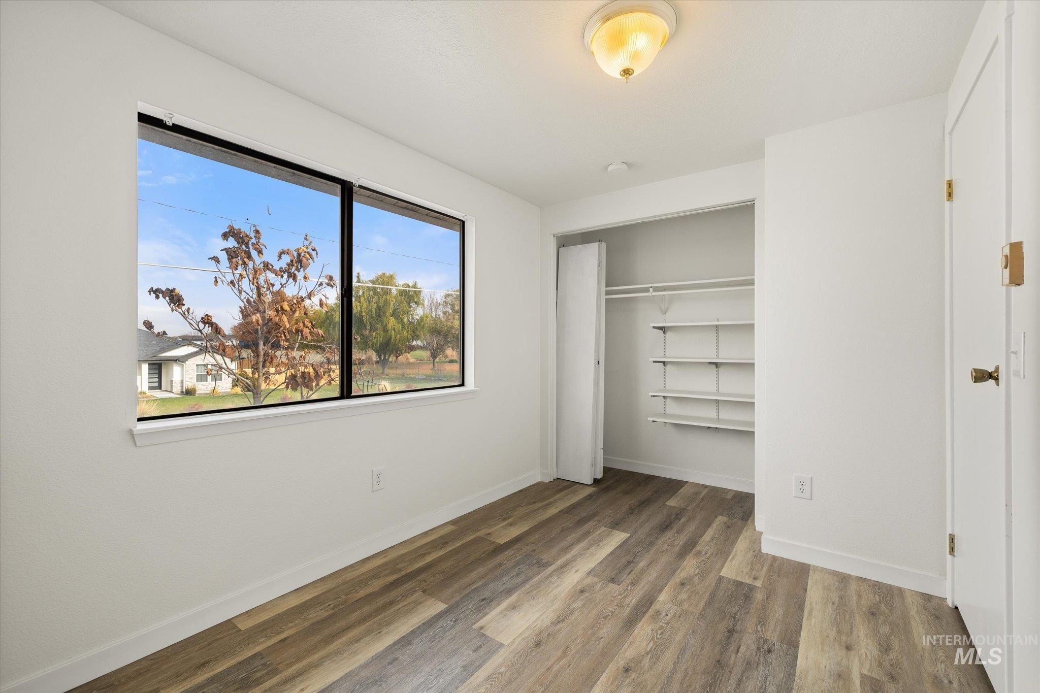 Unfurnished bedroom with a closet and light wood-style flooring