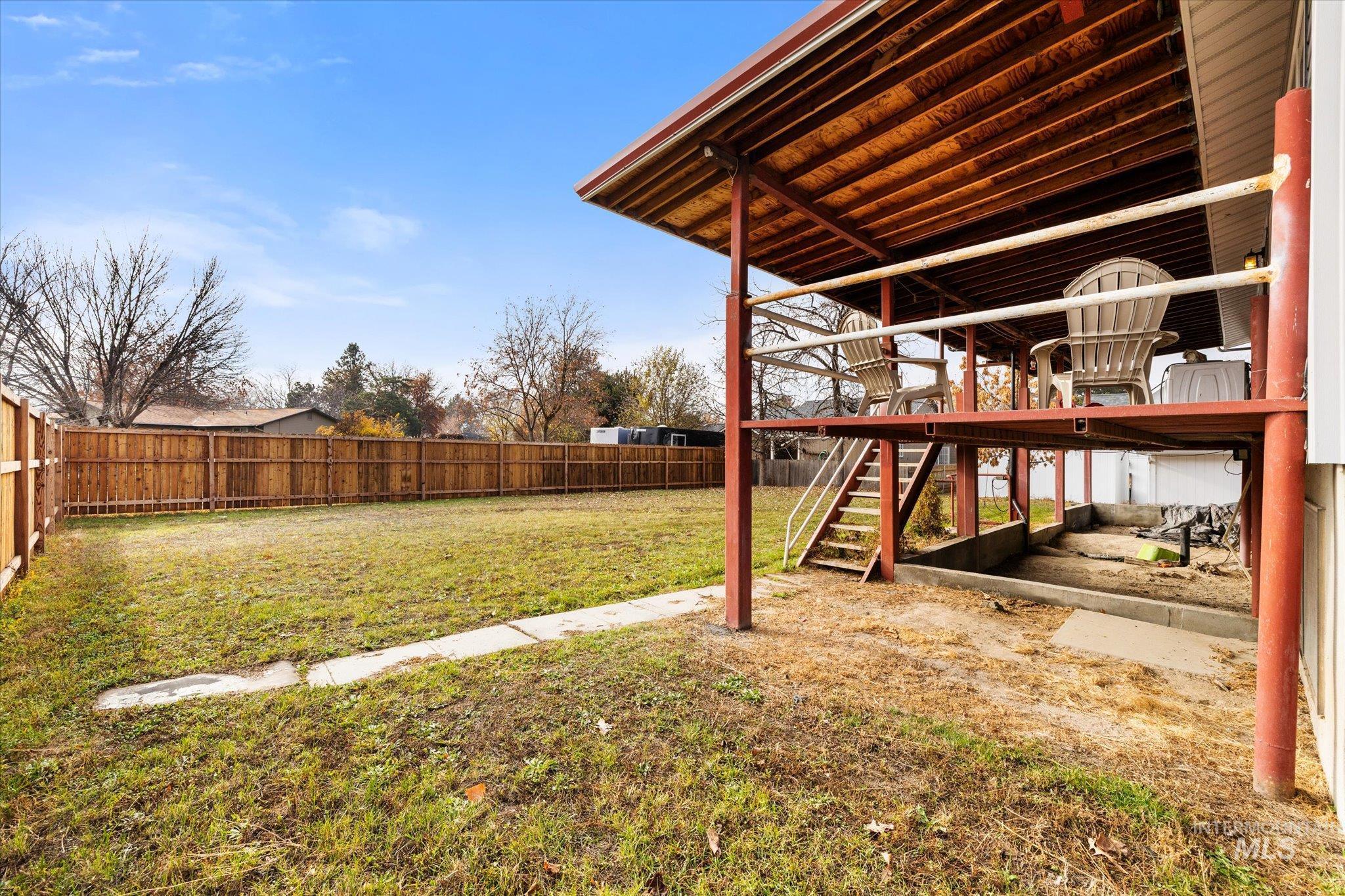 Fenced backyard with stairs