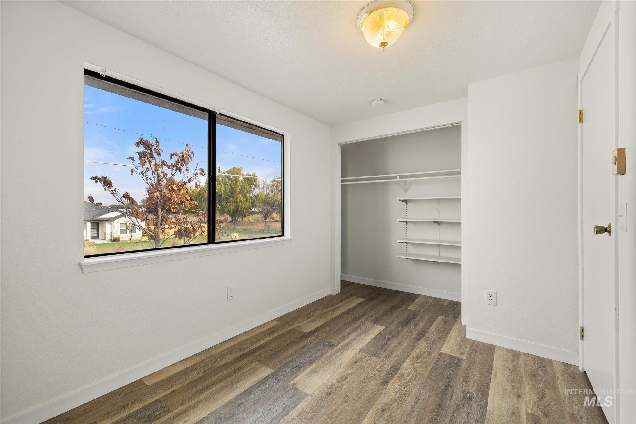Unfurnished bedroom with a closet and light wood finished floors