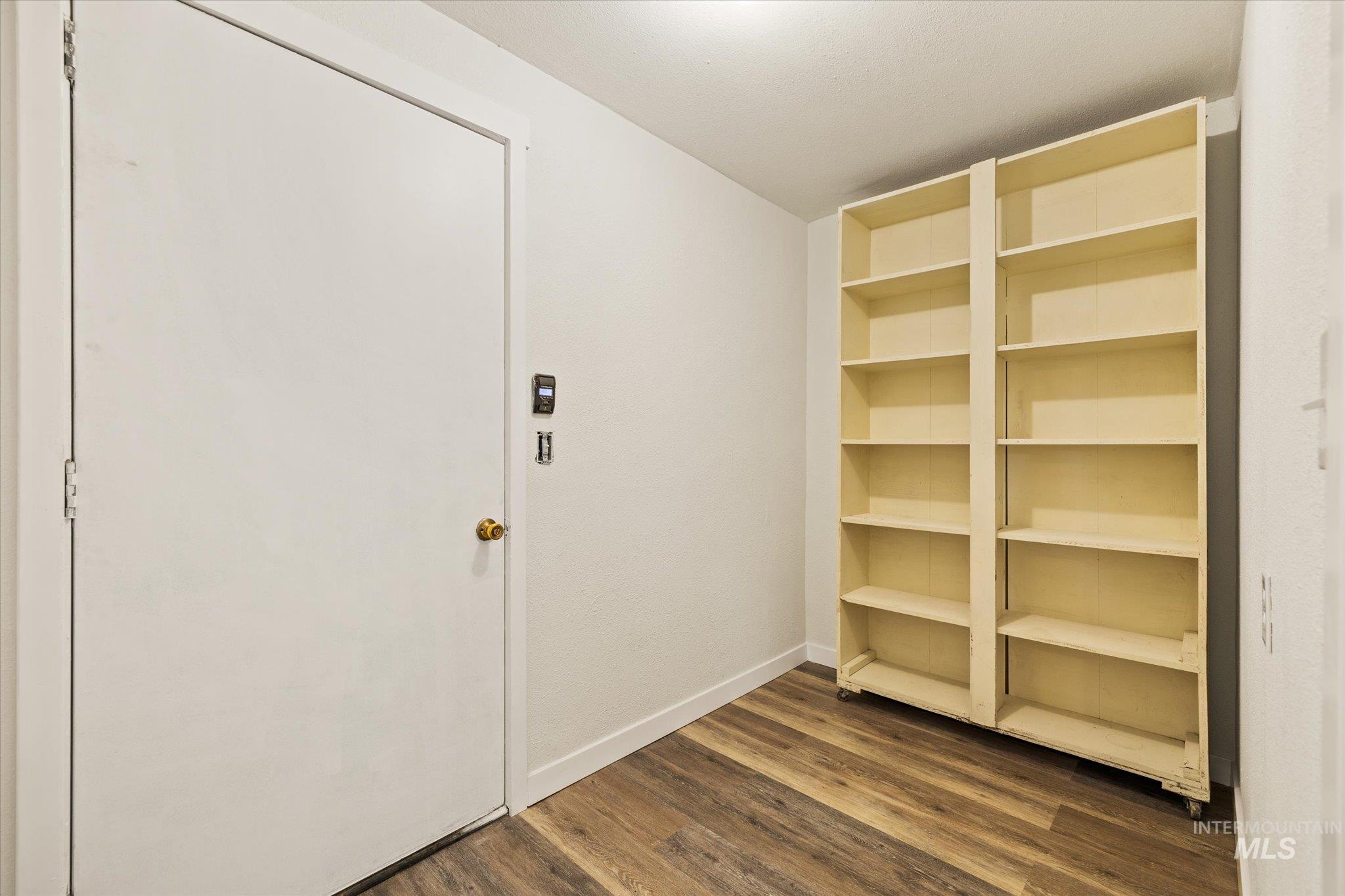 Interior space with wood finished floors and baseboards