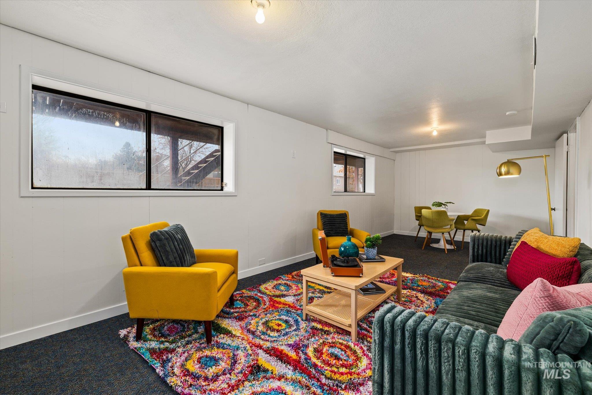 Living area featuring dark colored carpet