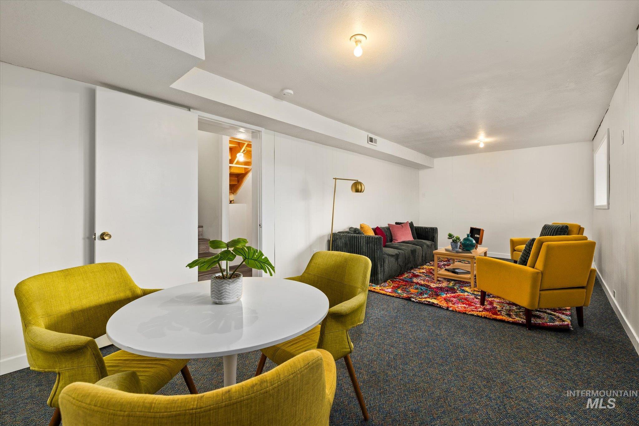 Carpeted dining space with baseboards