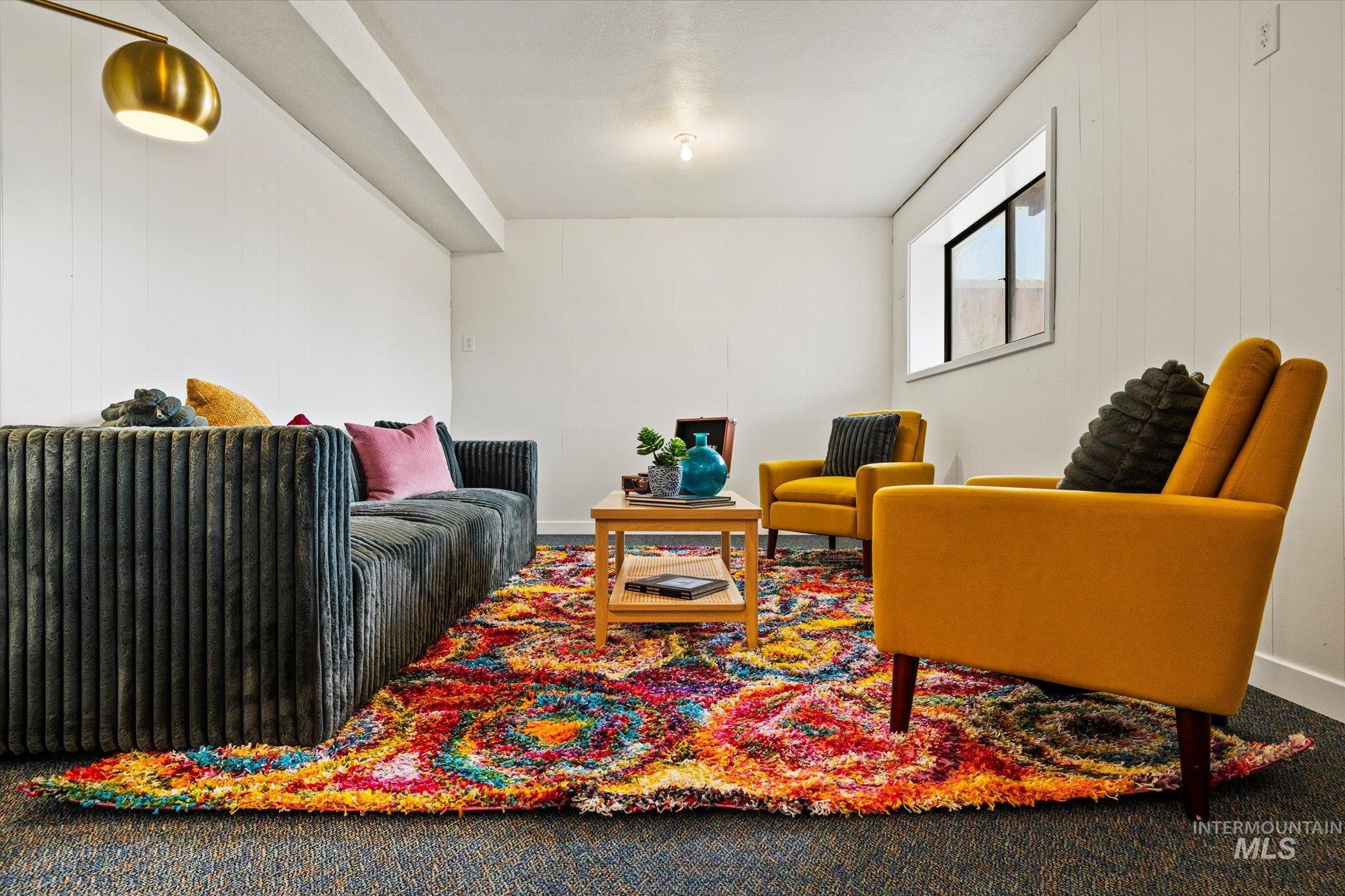 Living area with carpet flooring and baseboards