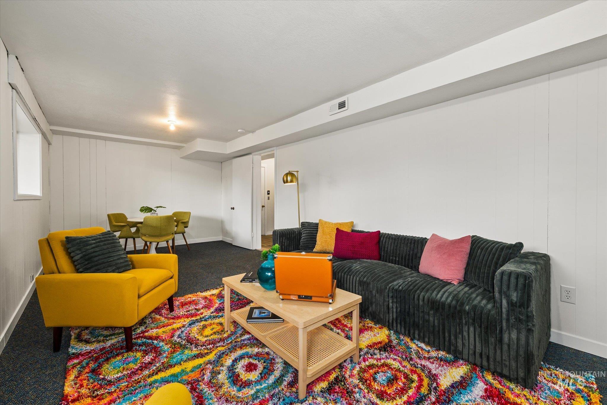 Living area with carpet floors and wooden walls