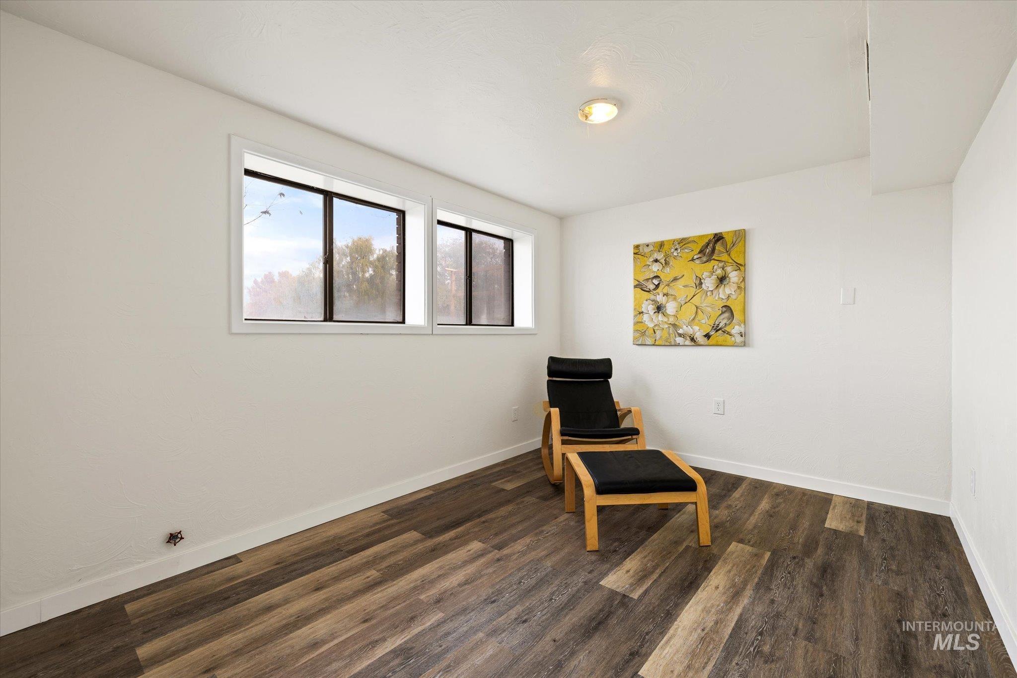Unfurnished room with dark wood-style flooring