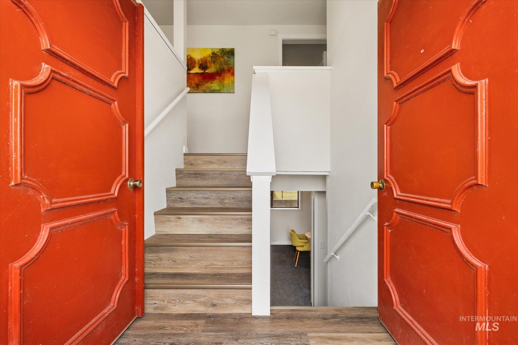 Staircase featuring wood finished floors