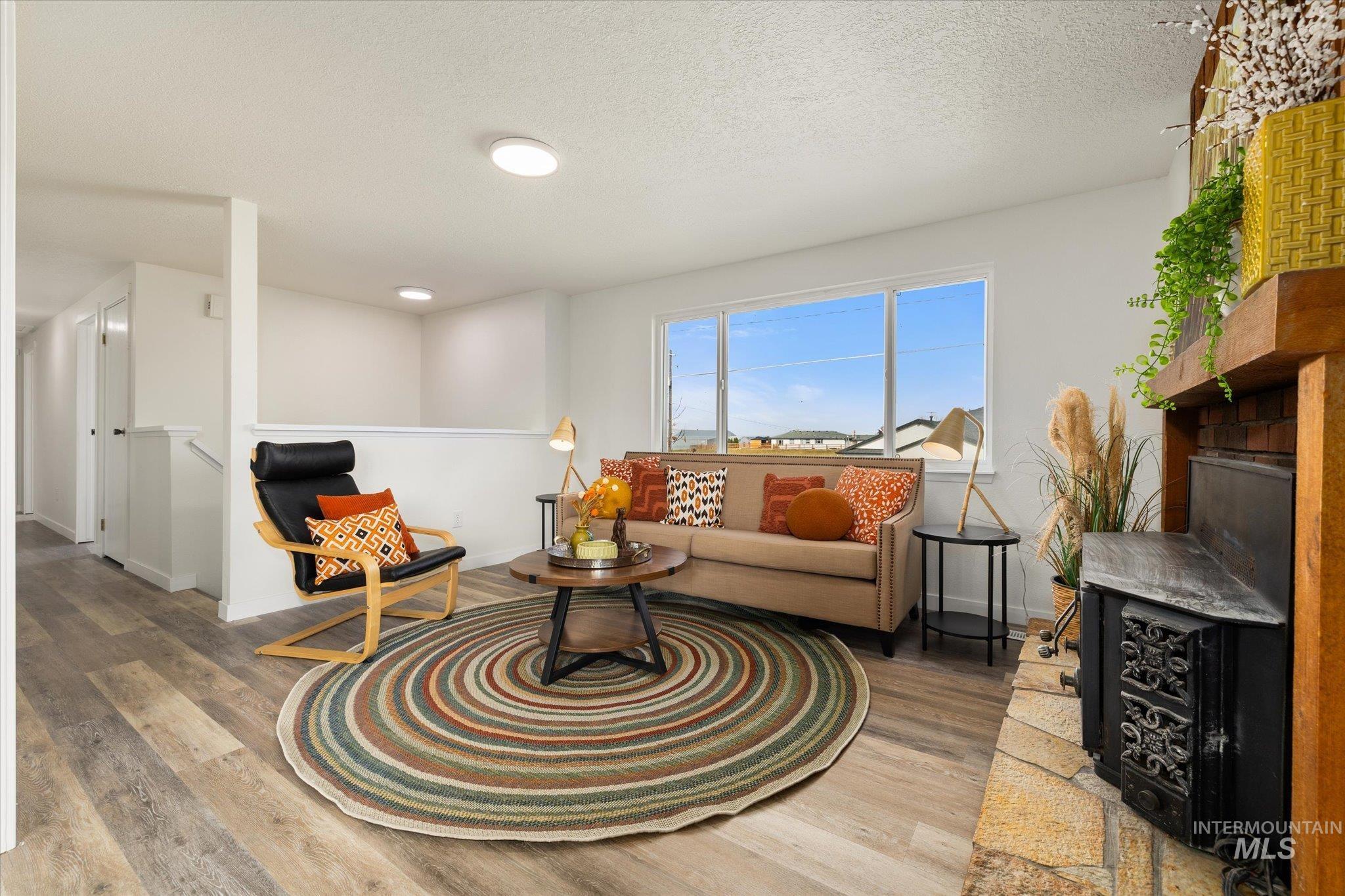 Living room with wood finished floors and a textured ceiling