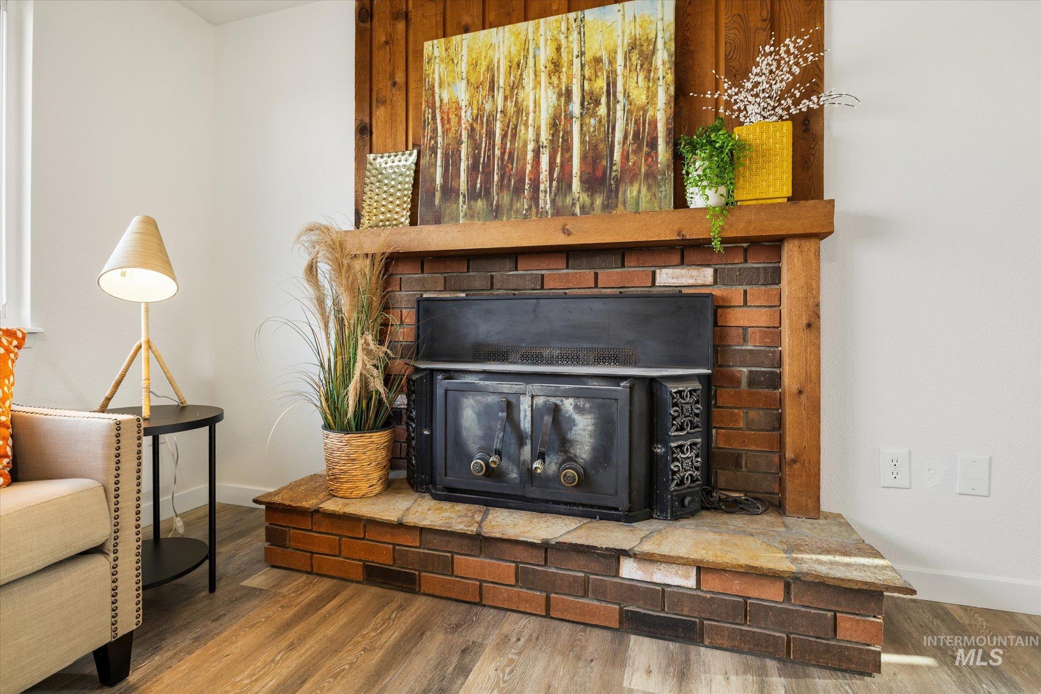 Detailed view of wood finished floors and a wood stove